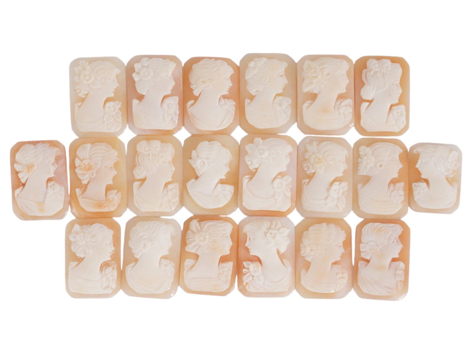 COLLECTION OF FEMALE PORTRAIT CARVED SHELL CAMEOS: A collection of hand carved shell cameos. A total of 20 items. Each piece depicts a female profile portrait rendered in high relief in the Victorian manner. Each cameo is fashioned in a distinctive oc