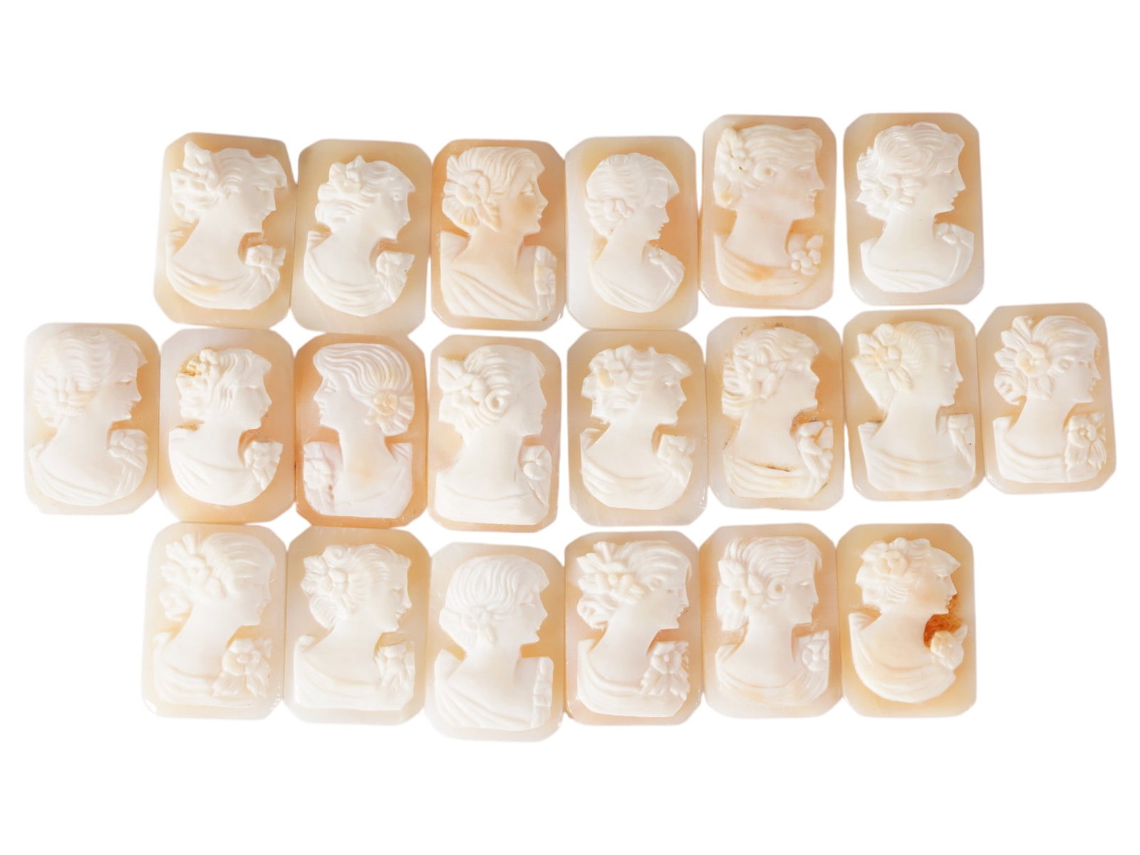 COLLECTION OF FEMALE PORTRAIT CARVED SHELL CAMEOS: A collection of hand carved shell cameos. A total of 20 items. Each piece depicts a female profile portrait rendered in high relief in the Victorian manner. Each cameo is fashioned in a distinctive oc