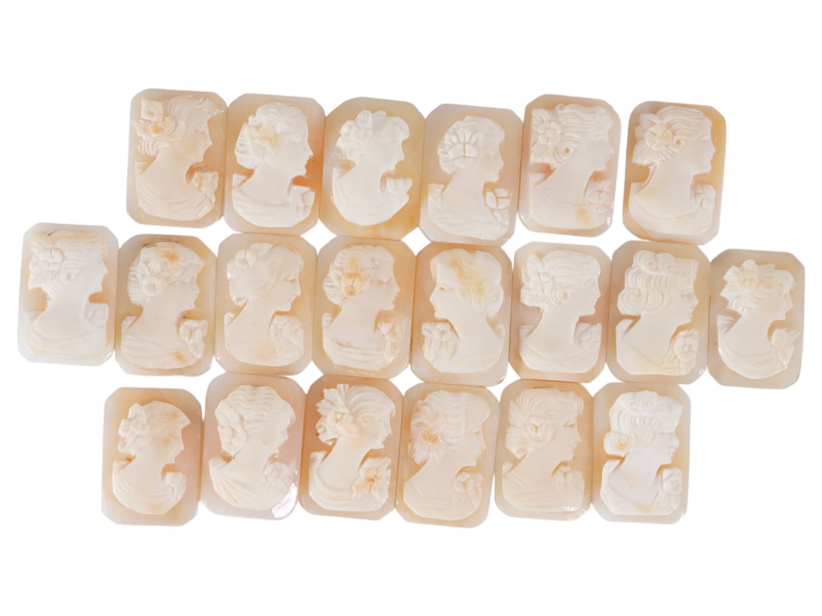 COLLECTION OF FEMALE PORTRAIT CARVED SHELL CAMEOS: A collection of hand carved shell cameos. A total of 20 items. Each piece depicts a female profile portrait rendered in high relief in the Victorian manner. Each cameo is fashioned in a distinctive oc