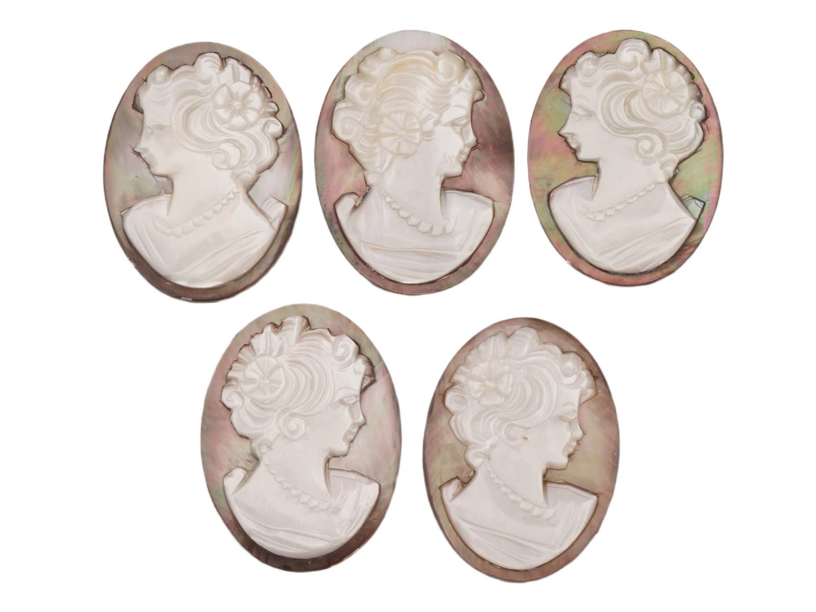 COLLECTION OF FEMALE PORTRAIT CARVED SHELL CAMEOS: A collection of hand carved conch shell cameos. A total of 5 items. Each piece is crafted from conch shells, featuring female profile portraits rendered in high relief. Oval shape. Collectible Jewelry