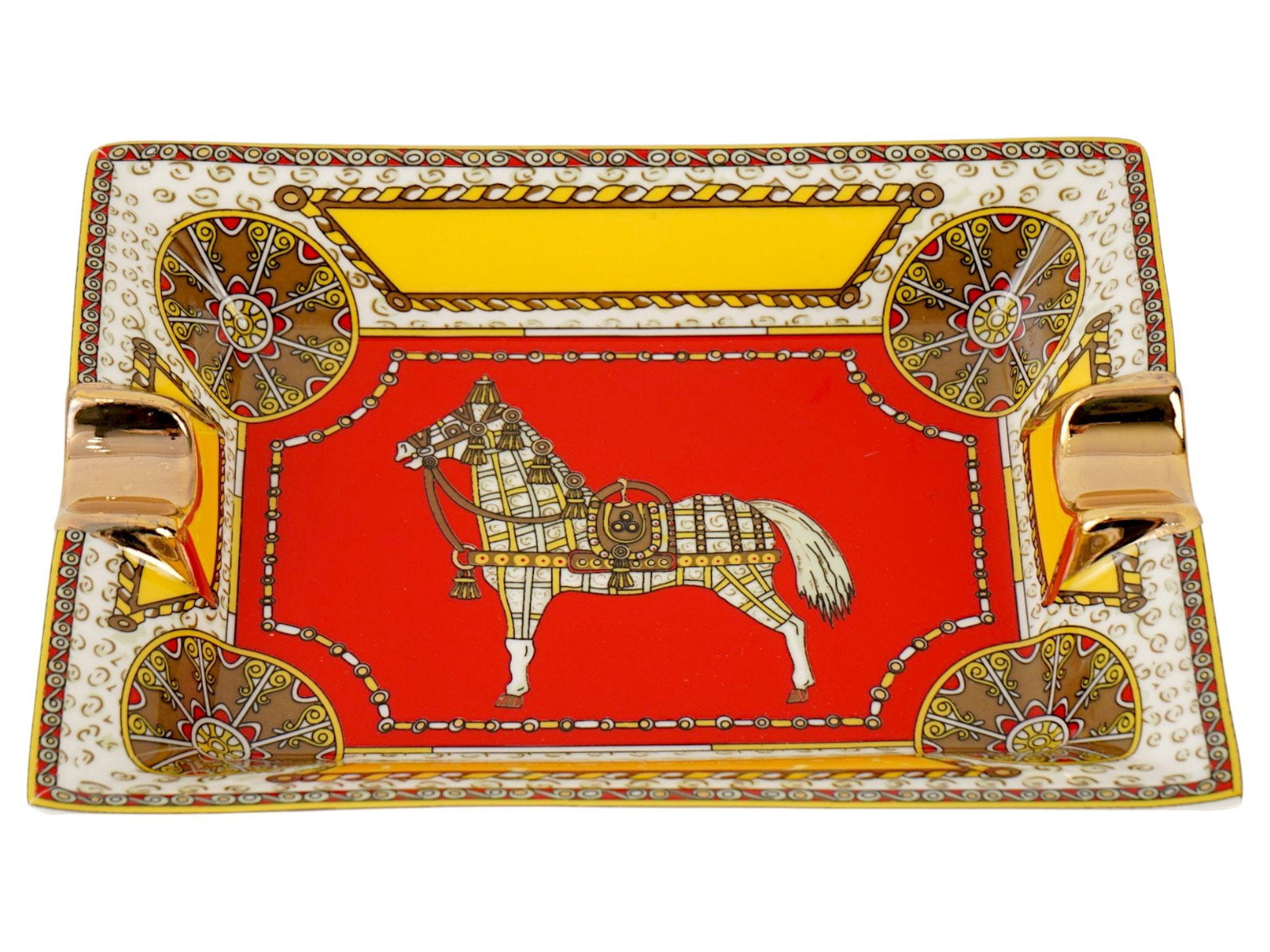 HERMES PARIS CHEVAL DORIENT PORCELAIN ASHTRAY: A porcelain ashtray by Hermes Paris from the Cheval dOrient collection. Rectangular piece with two gilt cigarette holders and transfer-printed oriental decoration in red featuring a horse in the cente