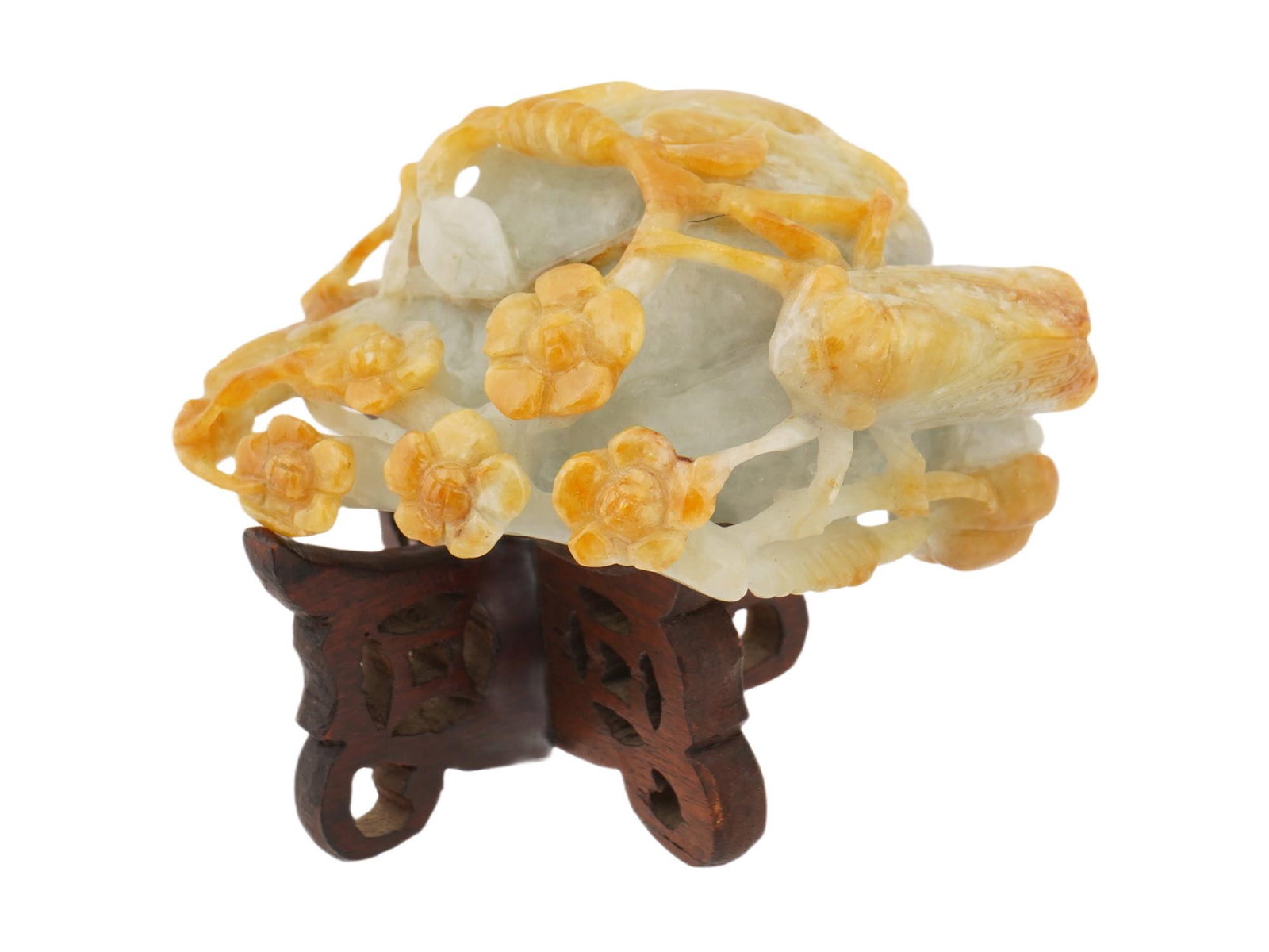 CHINESE FLORAL CARVED JADE FIGURE ON WOOD STAND: A Chinese carved sculpture made of Jade, depicting plum blossoms. The carving is made using a high relief technique, skillfully using the natural color of the stone to highlight the buds and flowers. 