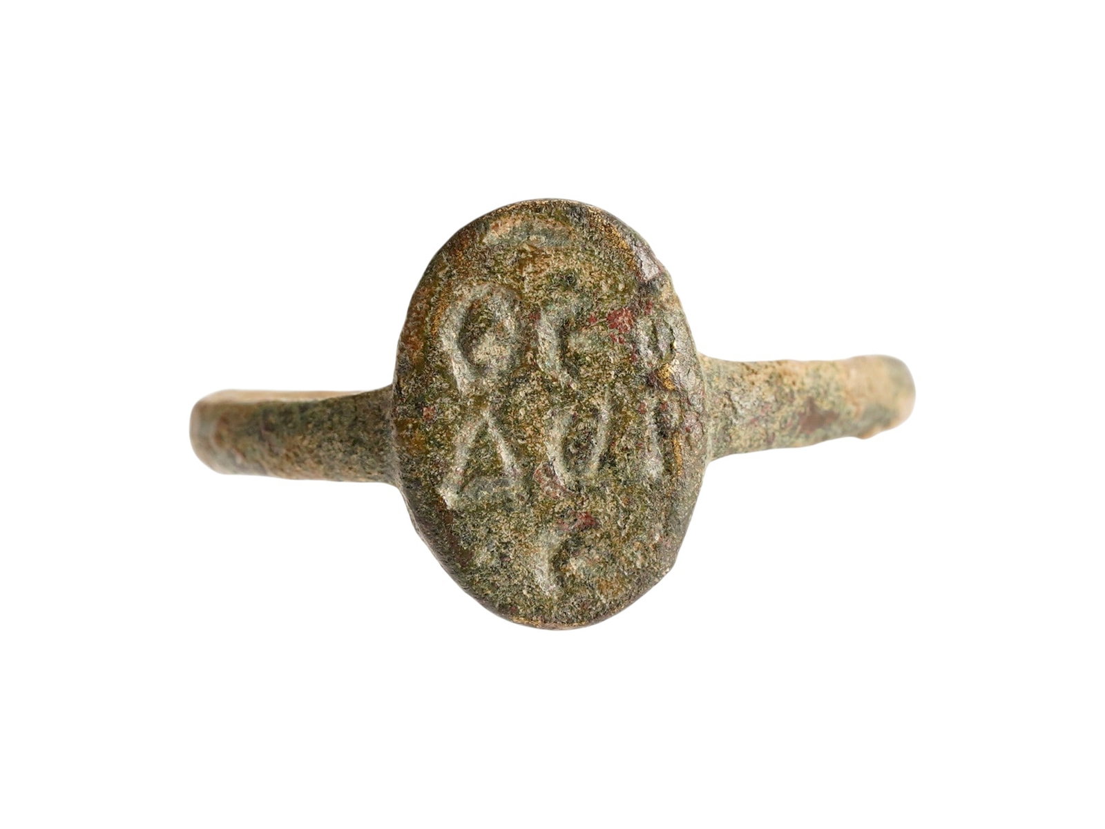 ANCIENT BYZANTINE BRONZE SIGNET RING 400 TO 600 AD: An ancient Byzantine cast bronze signet ring, dating from approximately 400 to 600 AD, features an oval bezel deeply incised with blessing inscriptions. Typical of the Early Byzantine period, such rin