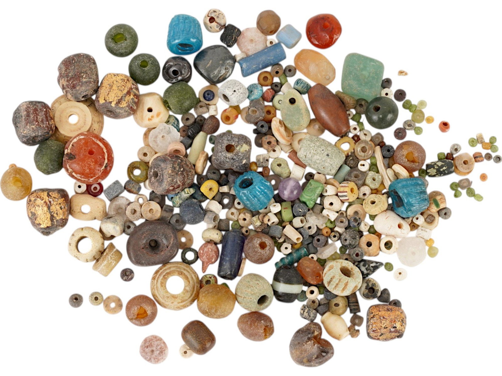 LOT OF ANCIENT EGYPTIAN LATE PERIOD BEADS 700 TO 200 BC: A collection of ancient Egyptian beads from the Late Period, ca. 700 to 200 BC, comprises a diverse selection of materials including glazed faience, carnelian, various glass beads and gilded beads. Th