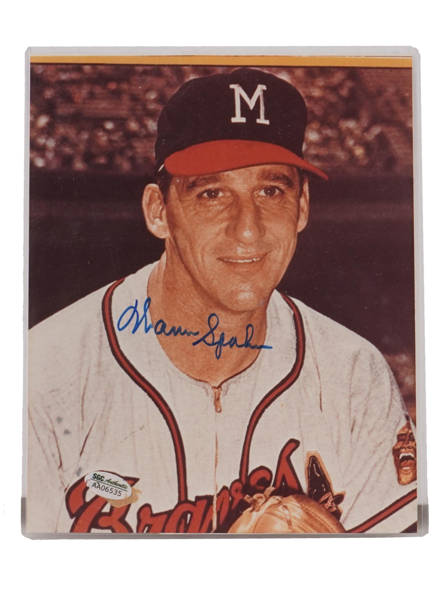 AMERICAN BASEBALL SPAHN AUTOGRAPHED SPORTS PHOTO COA: A vintage American color photograph depicting photograph of legendary Major League Baseball MLB pitcher Warren Spahn. The signature is in blue ink or marker on the light colored portion of the uniform