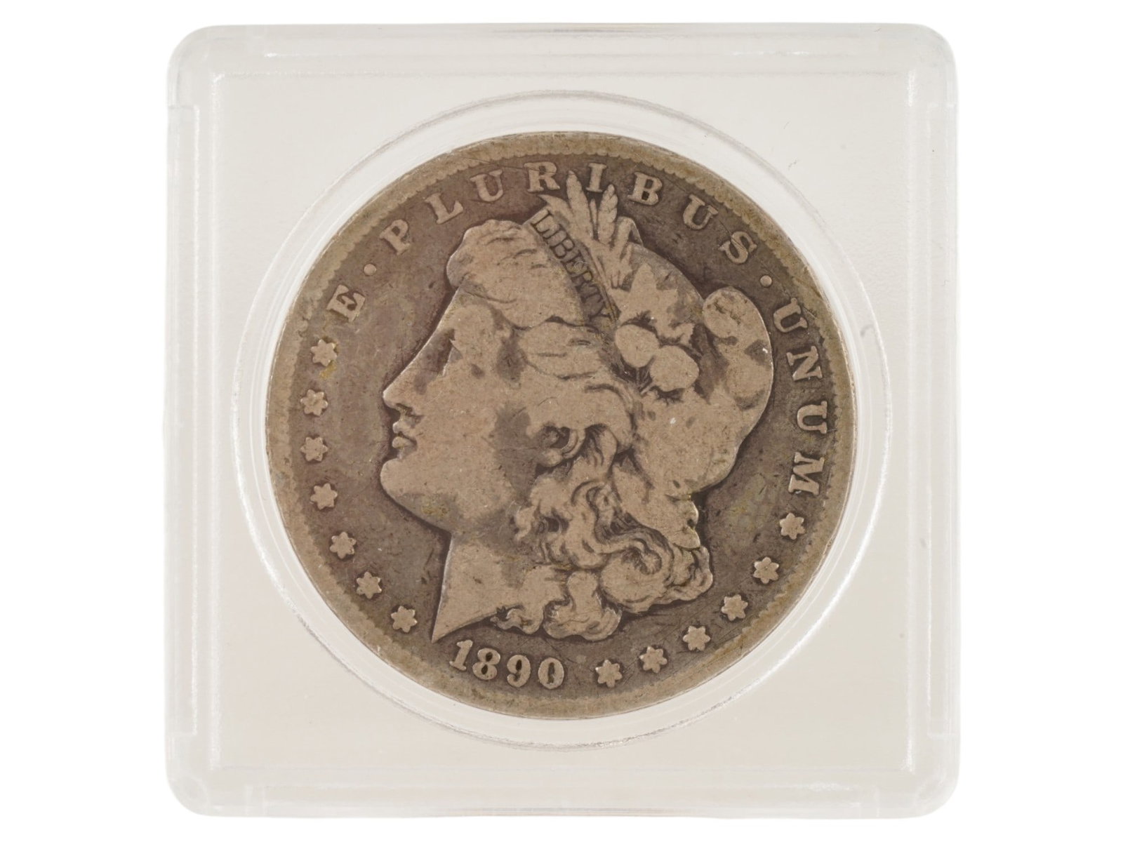 1890 AMERICAN CC MORGAN SILVER DOLLAR TONER COIN: An 1890 American silver dollar CC Carson City Dirty Toner, known as the Morgan dollar. 900 proof sterling silver. Designed by George T. Morgan. The obverse depicts the head of Liberty wearing a crown