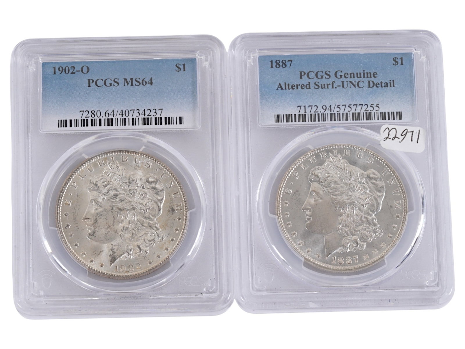 ANTIQUE AMERICAN GRADED SILVER MORGAN DOLLAR COINS: A lot of two American 1902 and 1887 silver Morgan dollars that have been professionally graded and encapsulated by the PCGS Guaranty Company. Certification Numbers: 7280.64 40734237 and 7172.94 575772