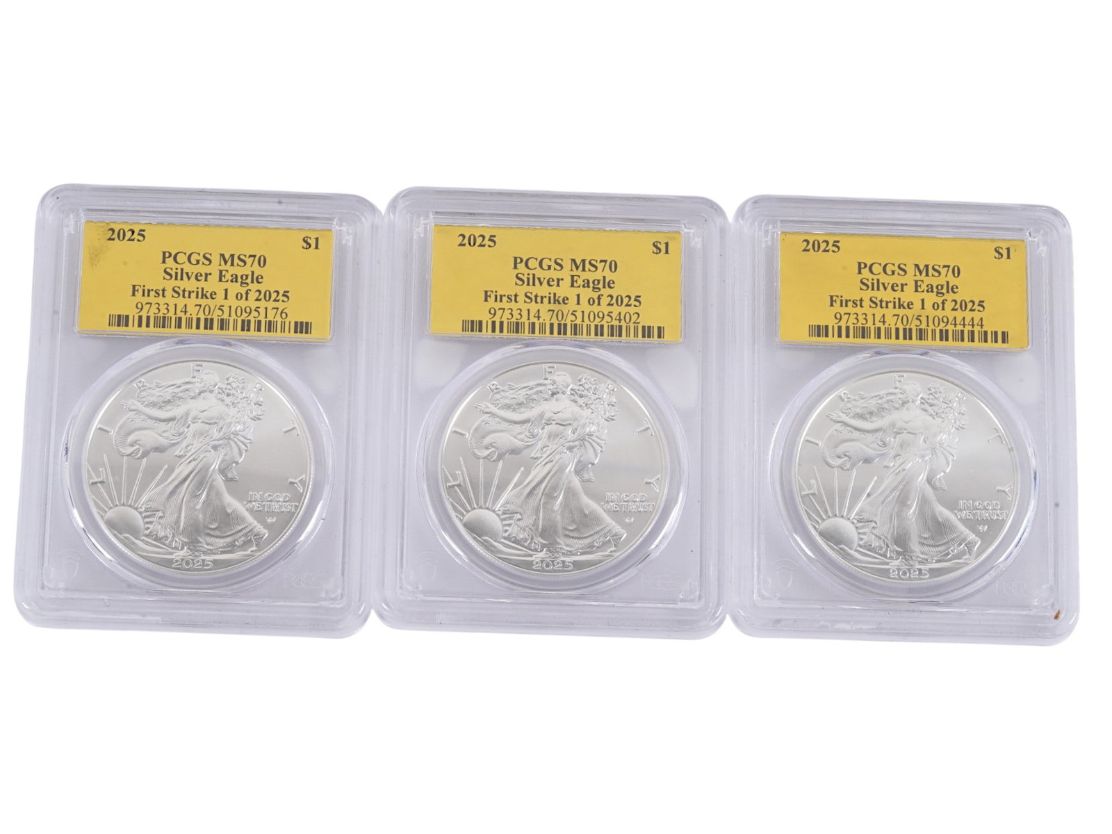 GRADED MS70 US SILVER EAGLE FIRST STRIKE DOLLAR COINS: A group of three American Silver Eagle First Strike one dollar coins, 2025. Each encapsulated in a protective case and graded MS70 by the PCGS. The American Silver Eagle is the official silver bullion