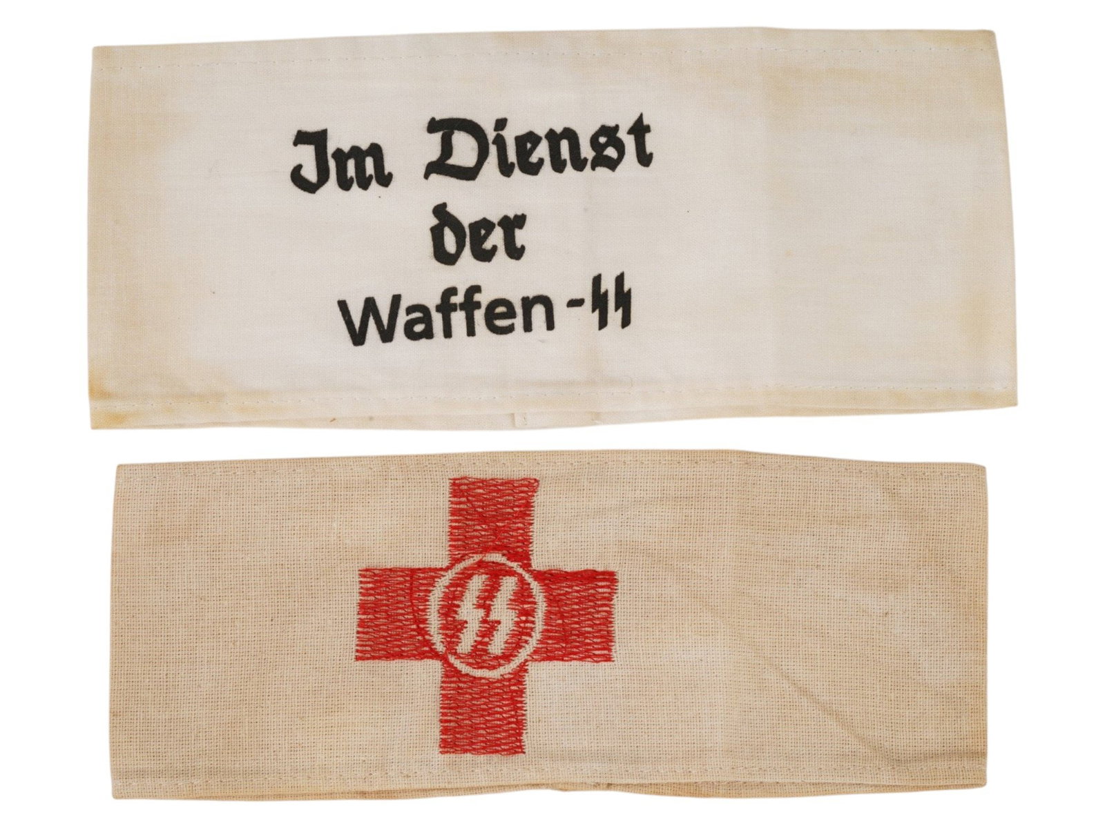 GERMAN WWII TYPE FABRIC WAFFEN SS RED CROSS ARMBANDS: A lot of two German WWII type fabric armbands. The lot contains an armband with printed inscription Im Dienst der Waffen-SS, On Service in Waffen SS and an embroidered armband SS Red Cross. Second Wor