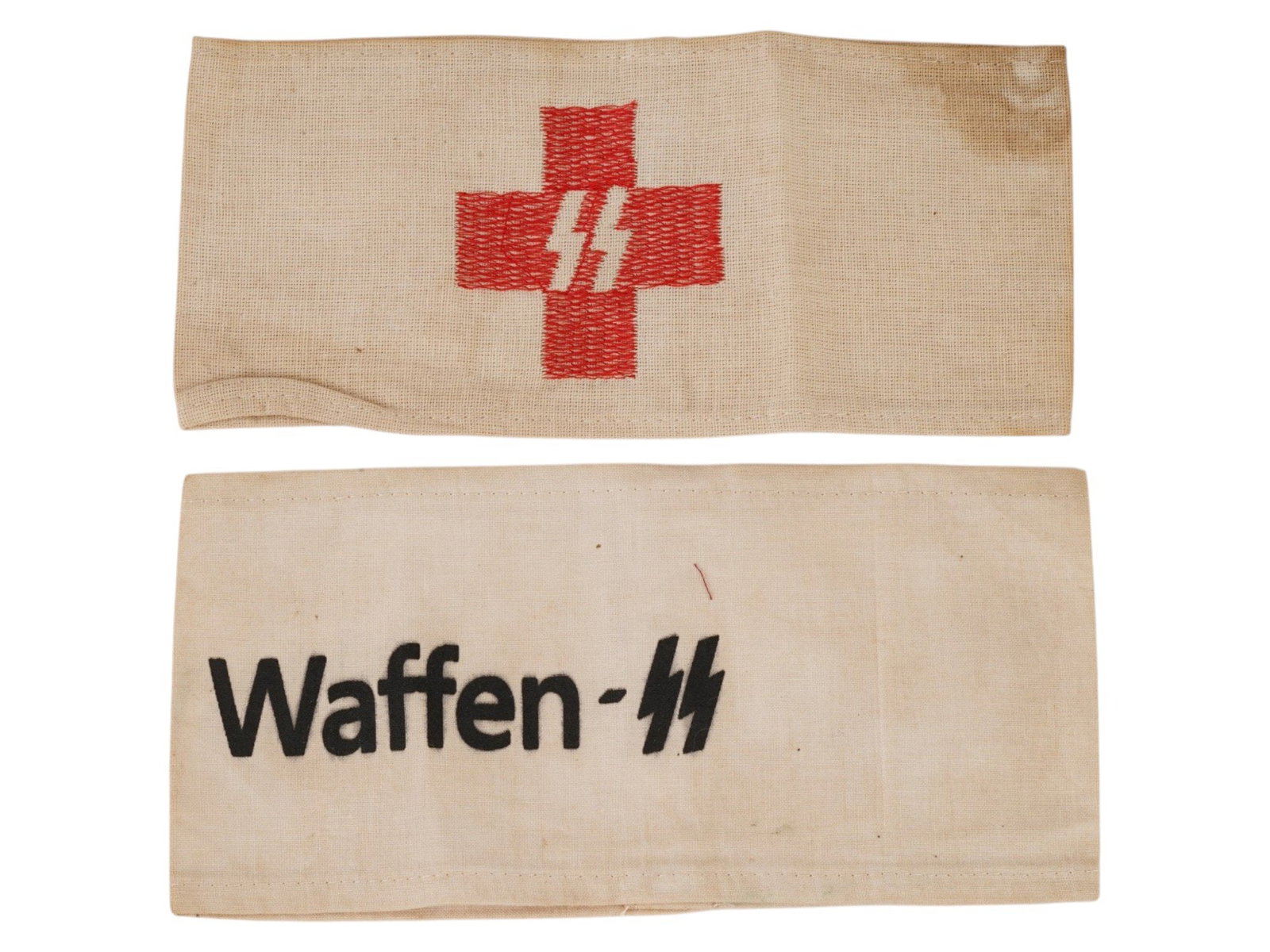 GERMAN WWII TYPE FABRIC WAFFEN SS RED CROSS ARMBANDS: A lot of two German WWII type fabric armbands. The lot contains an armband with printed inscription Im Dienst der Waffen-SS, On Service in Waffen SS and an embroidered armband SS Red Cross. Second Wor