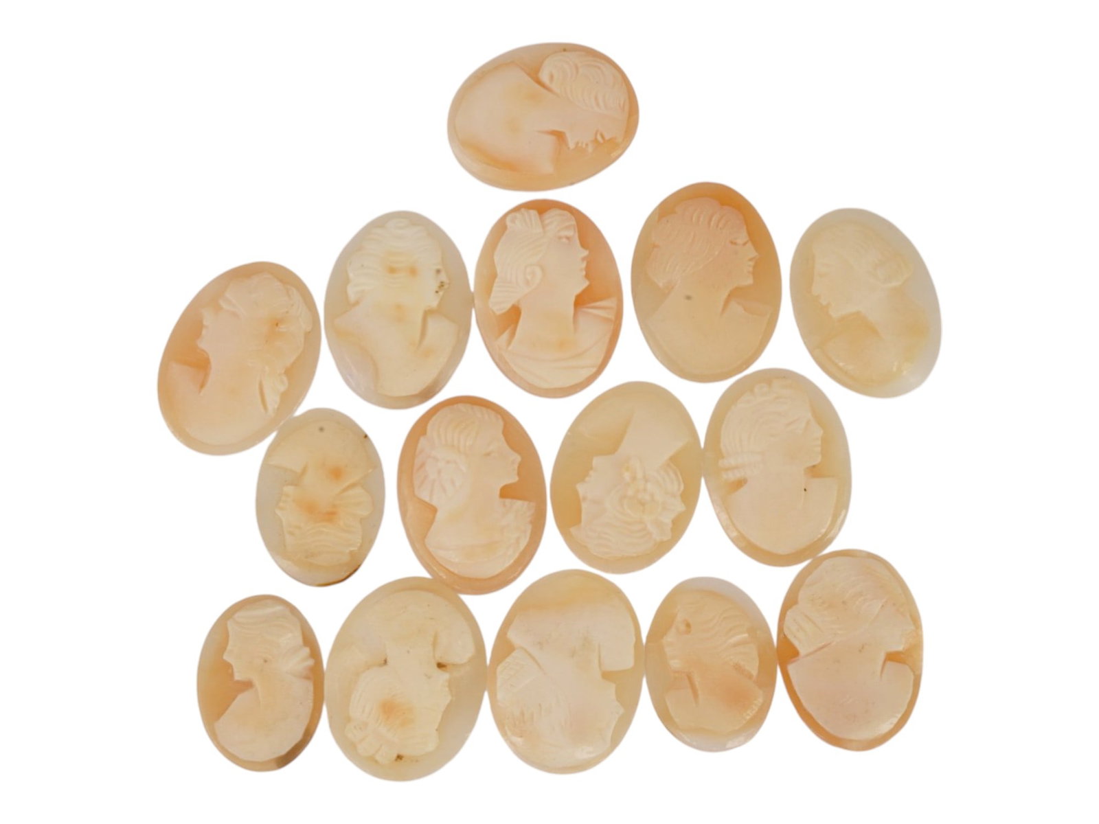 COLLECTION OF CARVED FEMALE PORTRAIT SHELL CAMEOS: A collection of hand carved shell cameos. A total of 15 items. Each piece depicts a female profile portrait rendered in high relief in the Victorian and Roman manners. Each cameo is fashioned in a dis