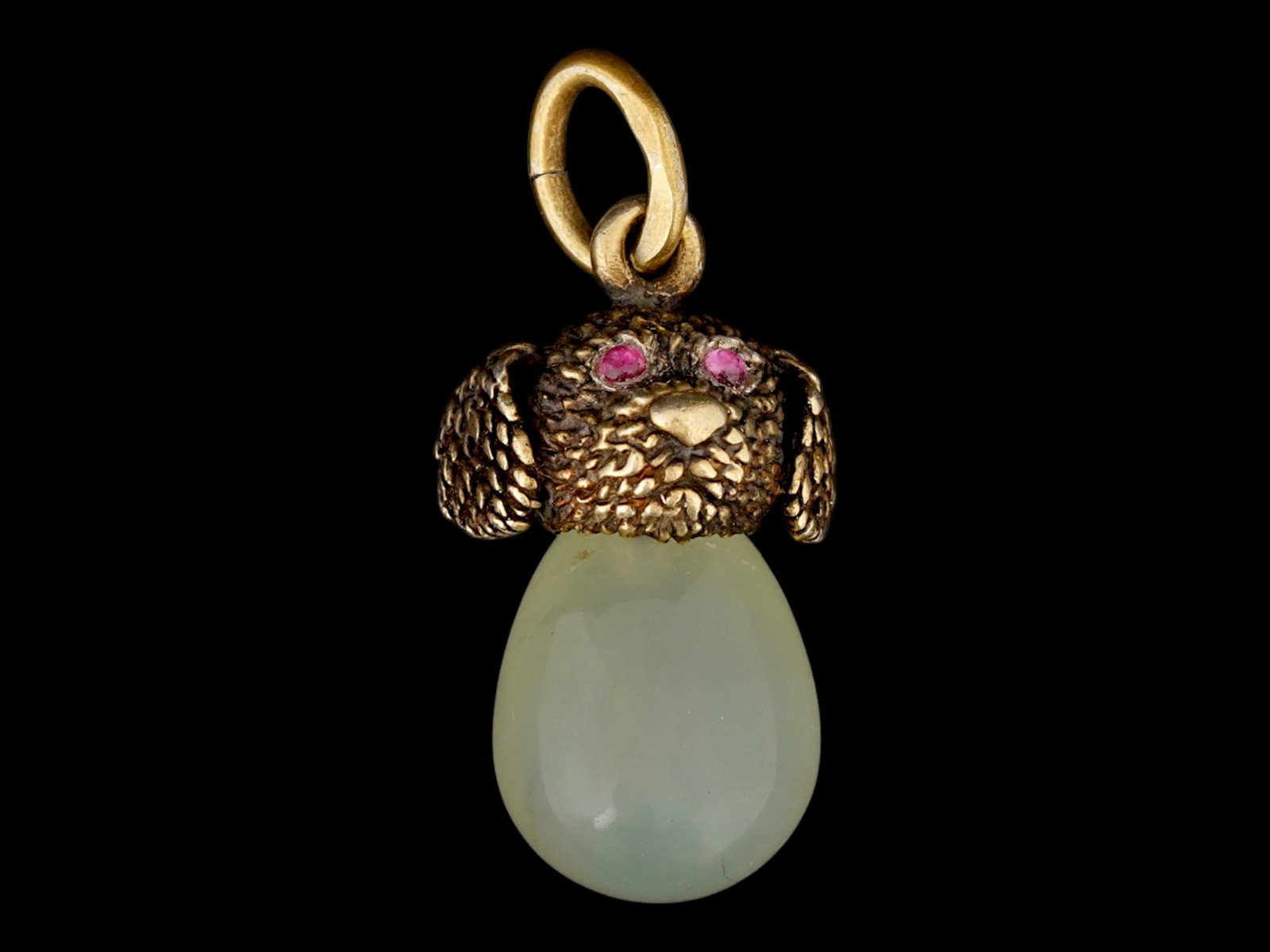 RUSSIAN GILT SILVER BOWENITE RUBY DOG EGG PENDANT: A Russian 88 gilt Silver and hand carved Bowenite Jade Easter Egg pendant. The egg is made from hand carved Bowenite Jade, and adorned with a gilt Silver figurine, made in the shape of a dogs head on