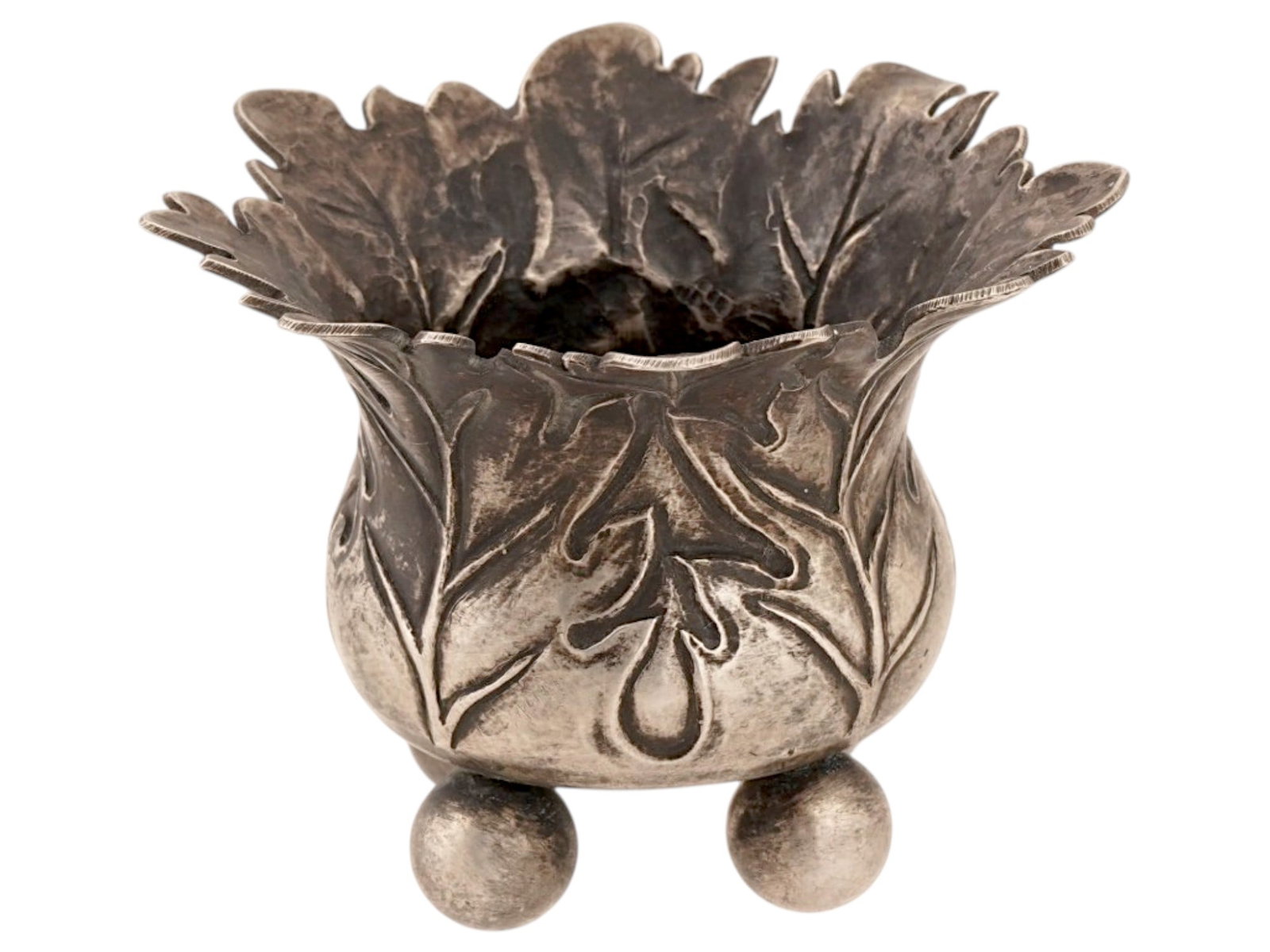 RUSSIAN HAND CHISELED SILVER LEAF SALT CELLAR: A Russian silver salt cellar features an expressive foliate design with a wide, flared rim fashioned as overlapping leaves. The body is adorned with hand-chiseled botanical patterns and is raised
