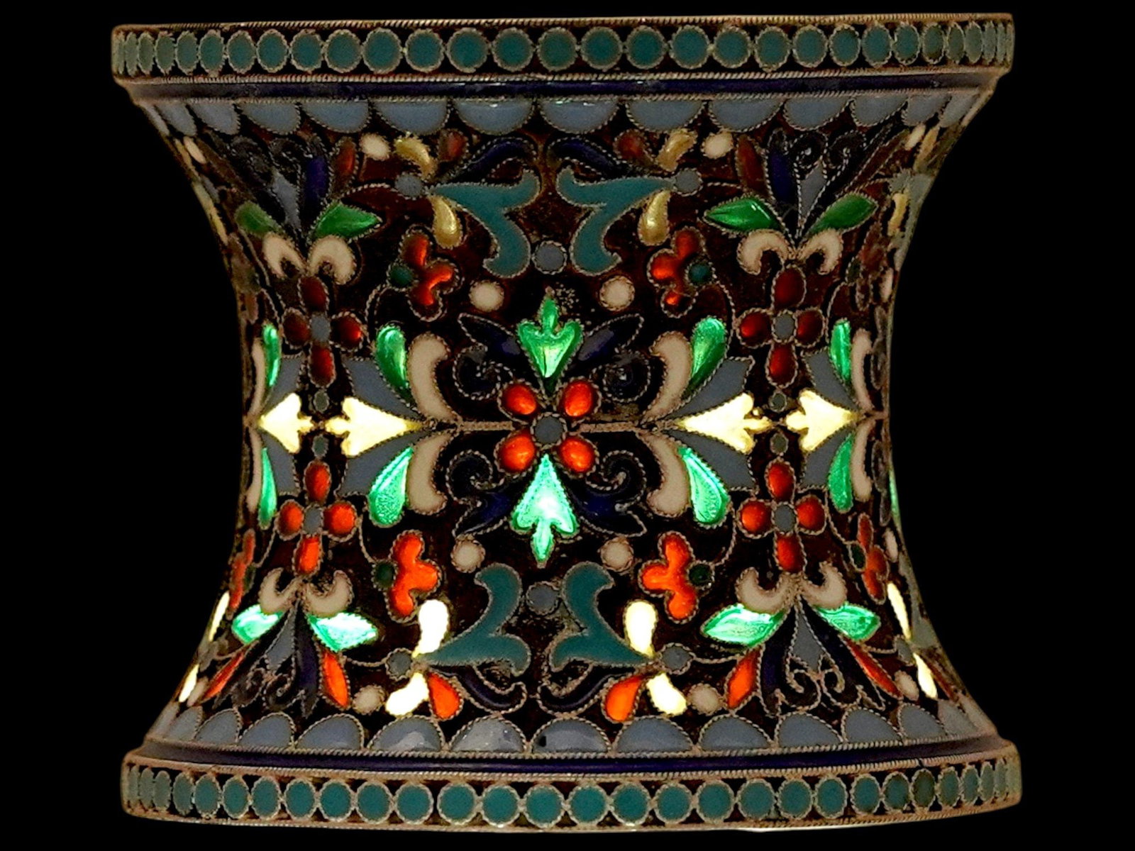 RUSSIAN SILVER PLIQUE A JOUR ENAMEL NAPKIN RING: A Russian gilt silver napkin ring adorned with multicolor floral and foliate enamel decorations made in the cloisonne and plique a jour technique. Hallmarked with the manufacturer and 88 Russian