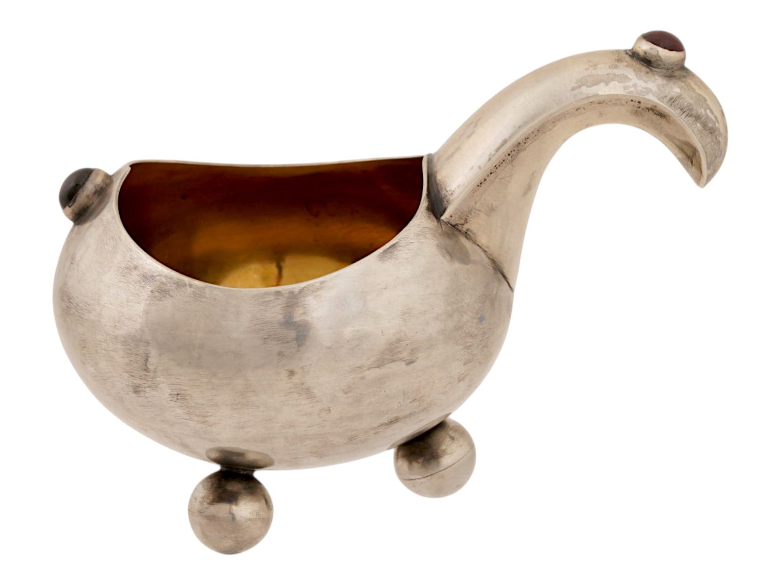 RUSSIAN 84 GILT SILVER KOVSH SET WITH GEMSTONES: A Russian silver kovsh of a characteristic oval form with gemstones. Features a gold washed interior, a curved handle and a body set with oval cabochon cut gemstones. Raised on four ball shaped feet.
