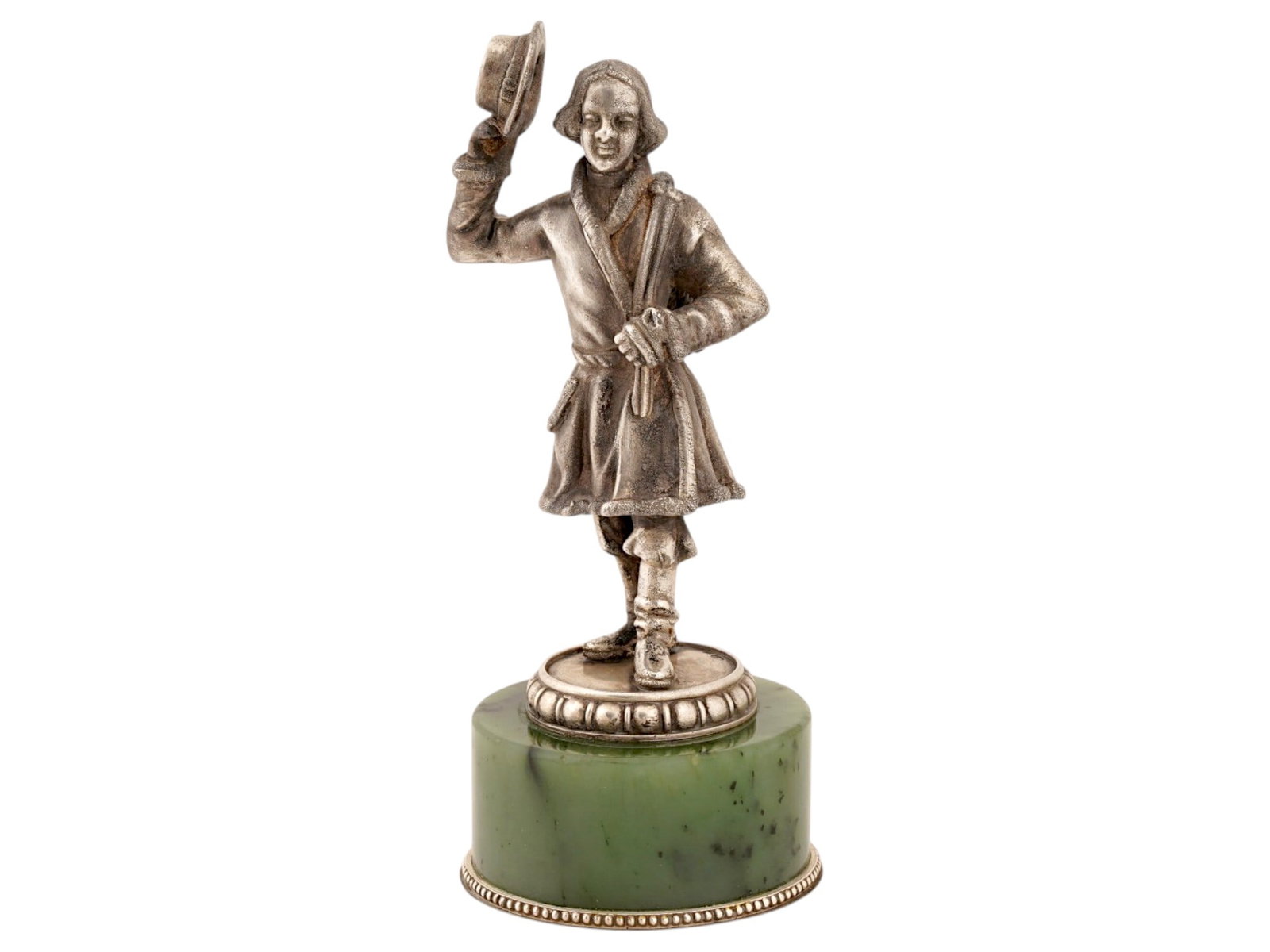 RUSSIAN BAGEL SALESMAN SILVER FIGURINE ON JADE BASE: A Russian 84 Silver figurine. The ware depicts a figure of a bagel salesman with a raised hand with a hat. Mounted on a carved spinach green Nephrite Jade base. marked with a Silver standard