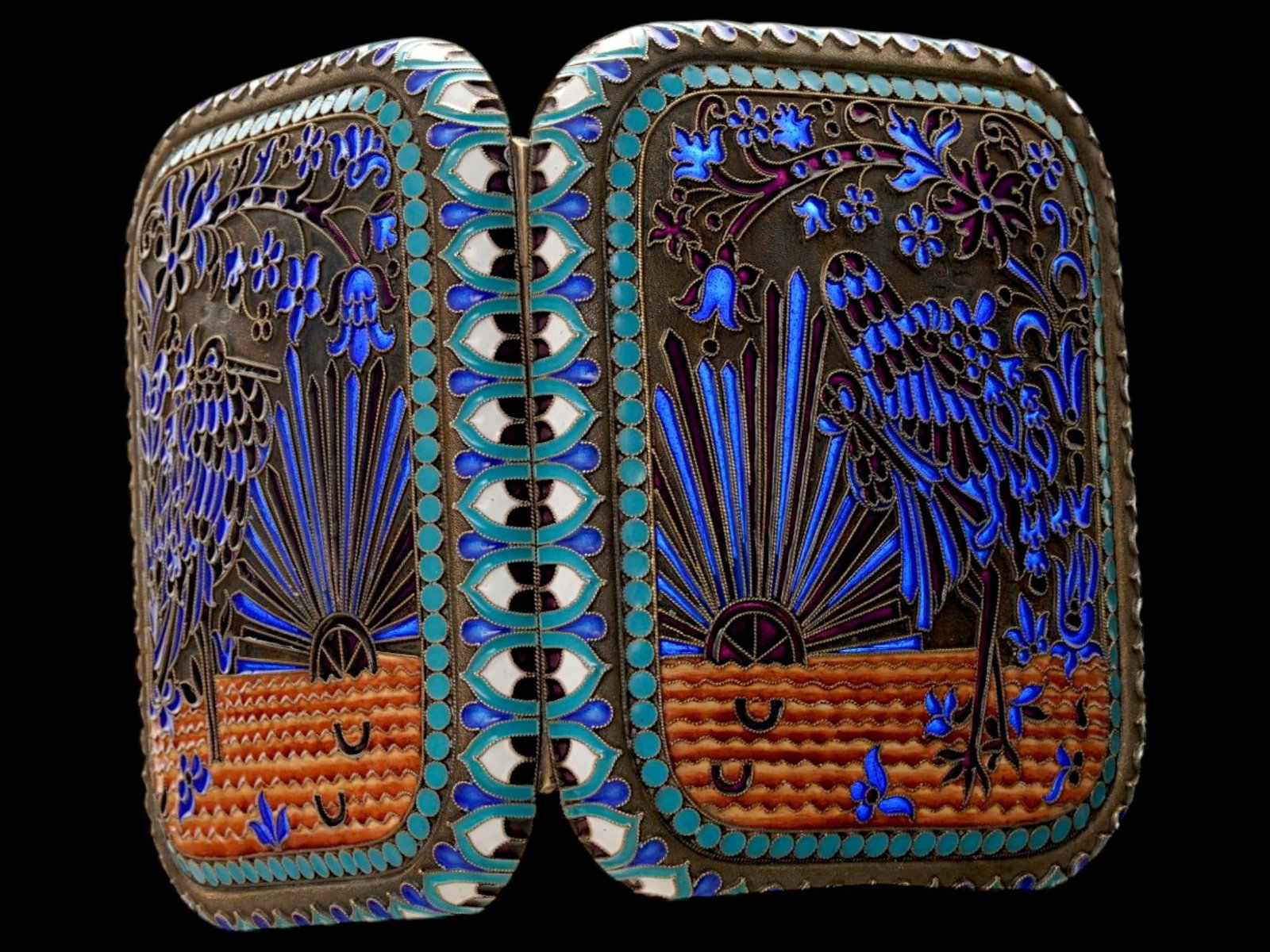 RUSSIAN PLIQUE A JOUR SILVER CIGARETTE CASE W GEMSTONES: A Russian 84 gilt silver cigarette case of rectangular form with rounded corners. The exterior is enameled with a scene depicting a bird, sun, sea, and flowers made in French Plique a Jour technique