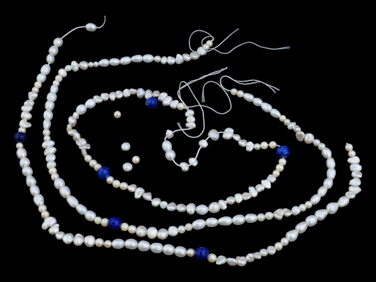 THREE STRINGS OF SMALL NATURAL BAROQUE PEARL BEADS: A lot of three strings of small natural baroque pearl beads, including oval shaped and rounded pearl beads. Jewelry, Freshwater Pearls And Jewelry Wares For Collectors. THIS LOT IS ELIGIBLE FOR A