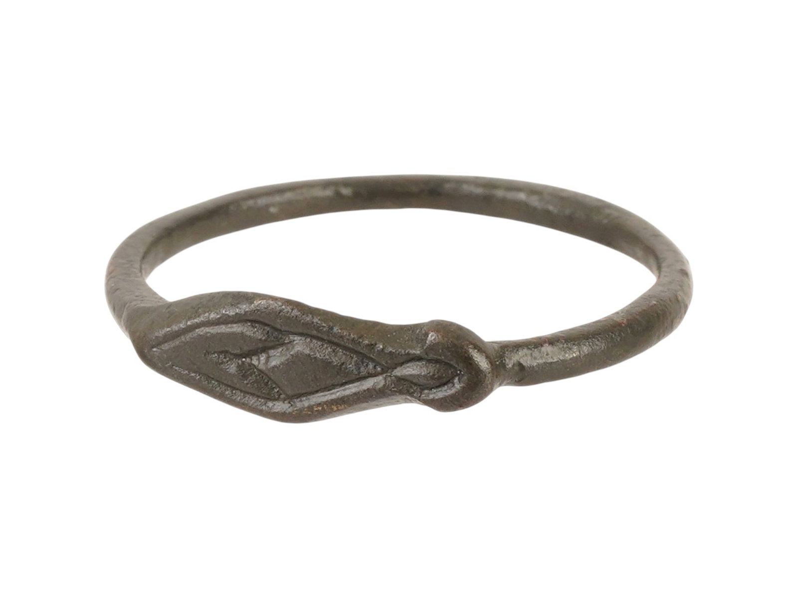 ANCIENT ROMAN BRONZE RING WITH A SLIPPER MOTIF: An ancient Roman bronze ring dating circa 100 to 300 AD, engraved with a slipper motif believed to serve as a protective symbol against evil. Such rings often functioned as personal amulets, combining