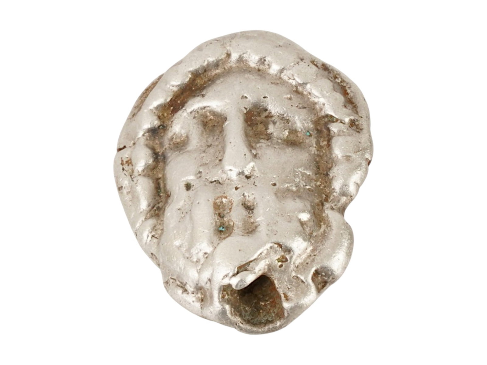 ANCIENT GREEK SILVER AMULET HEAD OF ZEUS 400 TO 200 BC: An ancient Greek double sided silver figural pendant amulet. Circa: 400 to 200 BC. The amulet features an engraved image representing a head of Zeus. Ancient Greek and Roman Silver Wares, Museum Piece