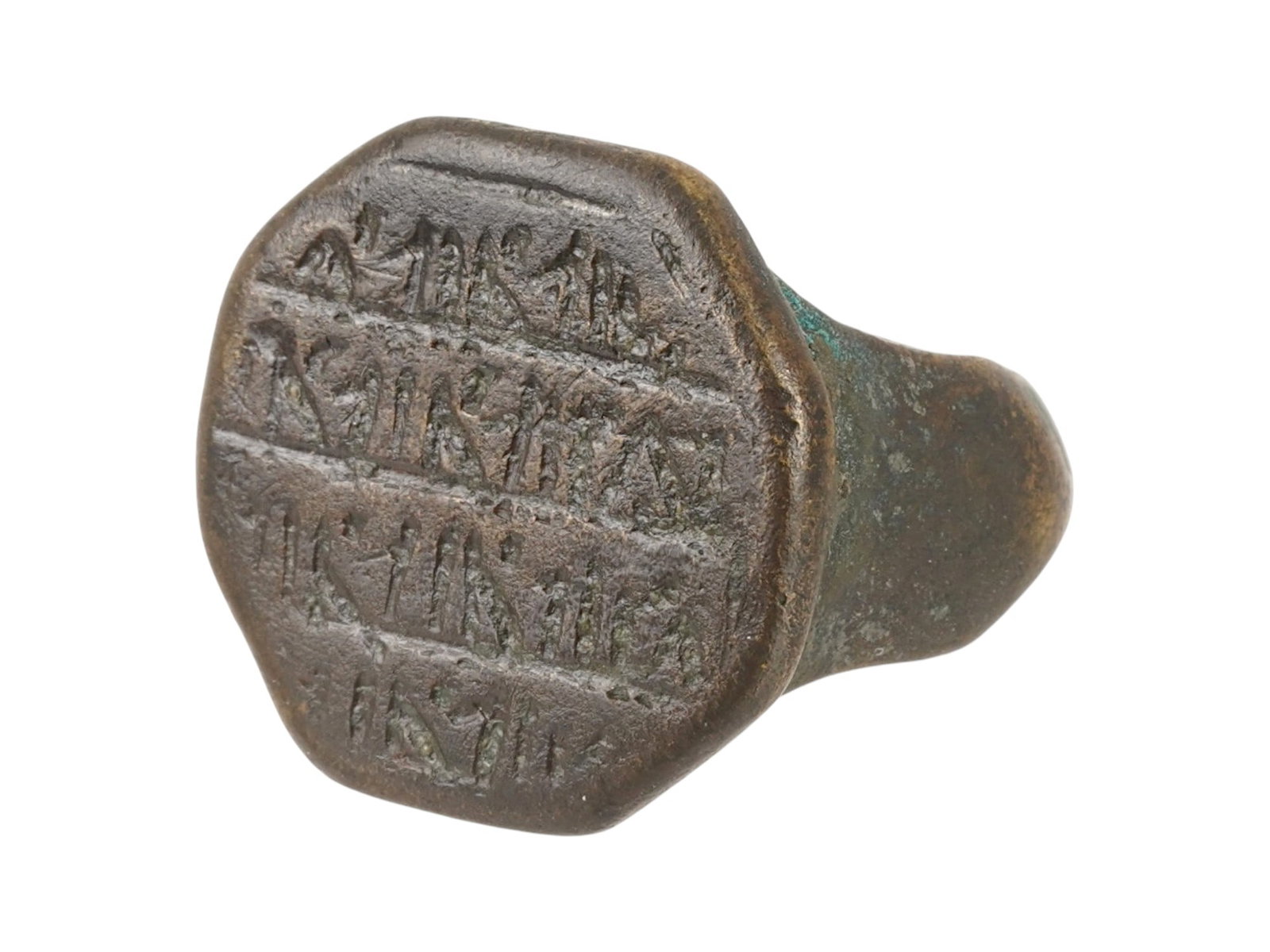 ANCIENT ISLAMIC ENGRAVED BRONZE RING 600 TO 800 AD: An ancient Islamic bronze ring, dating circa 600 to 800 AD. The ring features an octagonal shaped bezel with engraved lines of letters, possibly magical letters for protection. Historical Finds And Ar