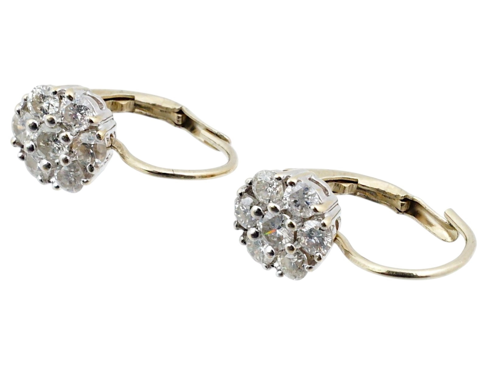VINTAGE 14K WHITE GOLD EARRINGS WITH DIAMONDS: A vintage 14K white gold earrings with diamonds. The earrings are designed in the shape of a flower, encrusted with seven equal-sized diamonds. Both are marked with 14K gold standard on the clasp. Lux