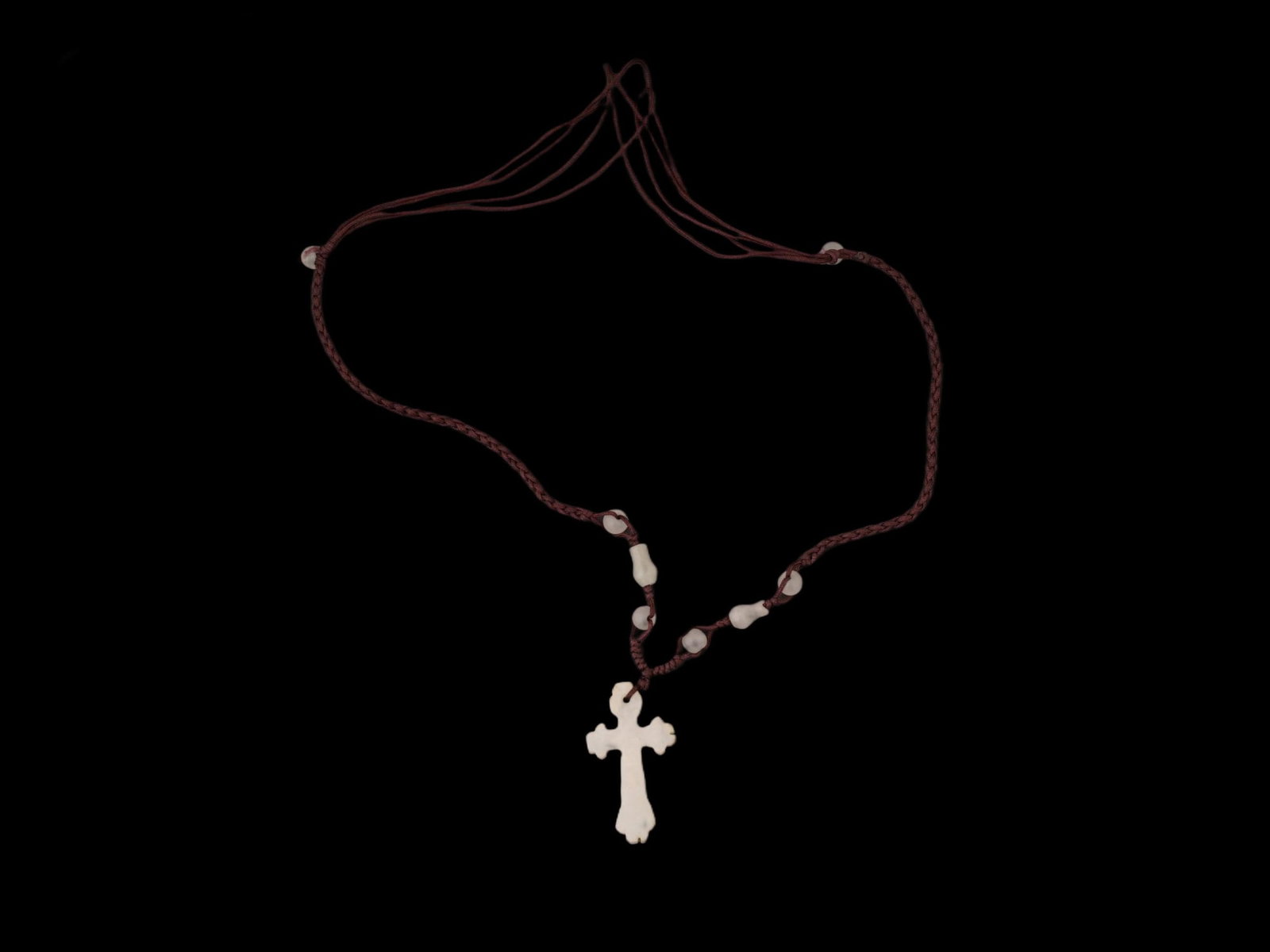 VINTAGE HETIAN WHITE JADE CROSS PENDANT: A vintage Hetian white jade Christian cross pendant on a weaved red cord with matching beads. Mineral Stone Jewelry And Religious Accessories. THIS LOT IS ELIGIBLE FOR A 30-DAY UNCONDITIONAL R