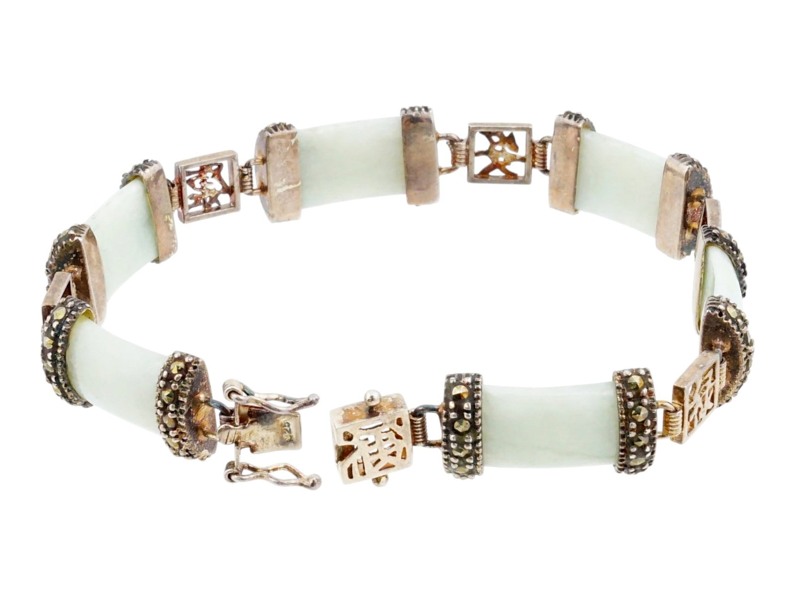 CHINESE STERLING SILVER SILVER AND WHITE JADE BRACELET: A vintage Chinese sterling silver link bracelet. Carved white jade links in riveted fittings are interspersed with pierced silver links representing symbols of luck. Marked 925 on the clasp. Total Wei
