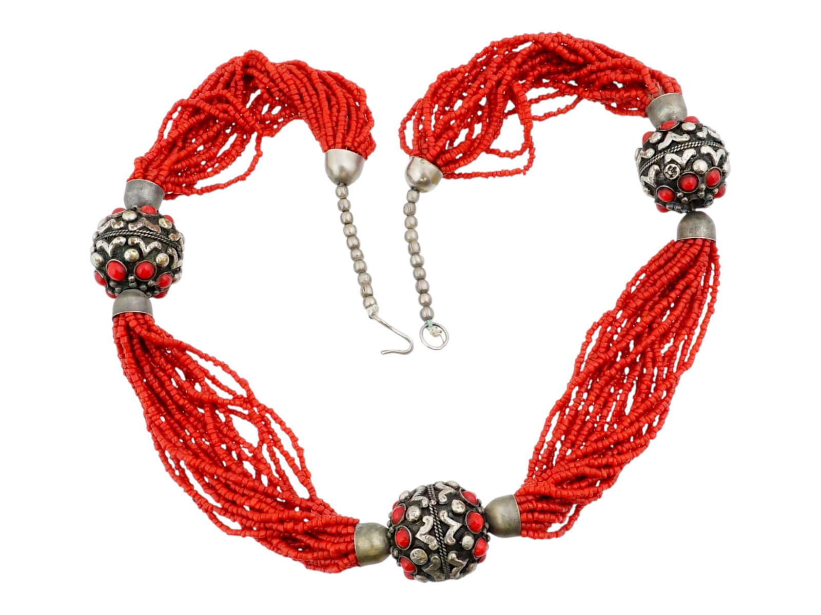 TIBETAN RED CORAL AND SILVER MULTI STRAND NECKLACE: A vintage Tibetean red coral multi-strand necklace. Composed of small coral beads. Silver globe spacers embellished with relief ornaments and coral cabochons. Ethnic And Tribal Jewelry, Oriental Acces