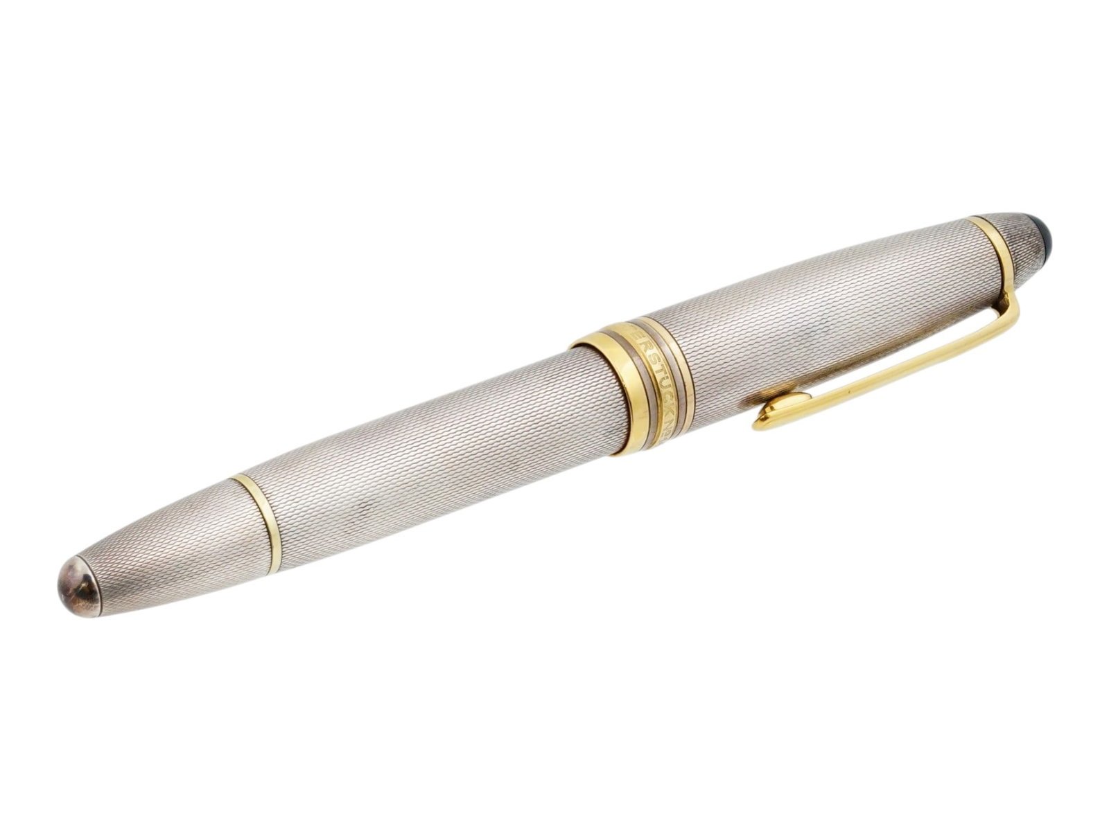MONTBLANC MEISTERSTUCK 146 STERLING SILVER FOUNTAIN PEN: A vintage fountain pen by Montblanc. Meisterstuck collection, model 146. Guilloche sterling silver body and cap with gilt accents, surmounted by the white star emblem. Fountain pen nib 4810 M, made of