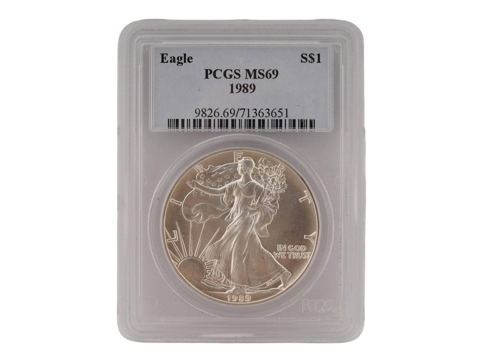 1989 SILVER EAGLE S ONE DOLLAR GRADED MS69 BY PCGS: A 1989 American Silver Eagle S One Dollar silver bullion coin. The coin is housed in a protective plastic holder slab. Graded MS69 by PCGS. The obverse design represents a female figure symbolizing Li