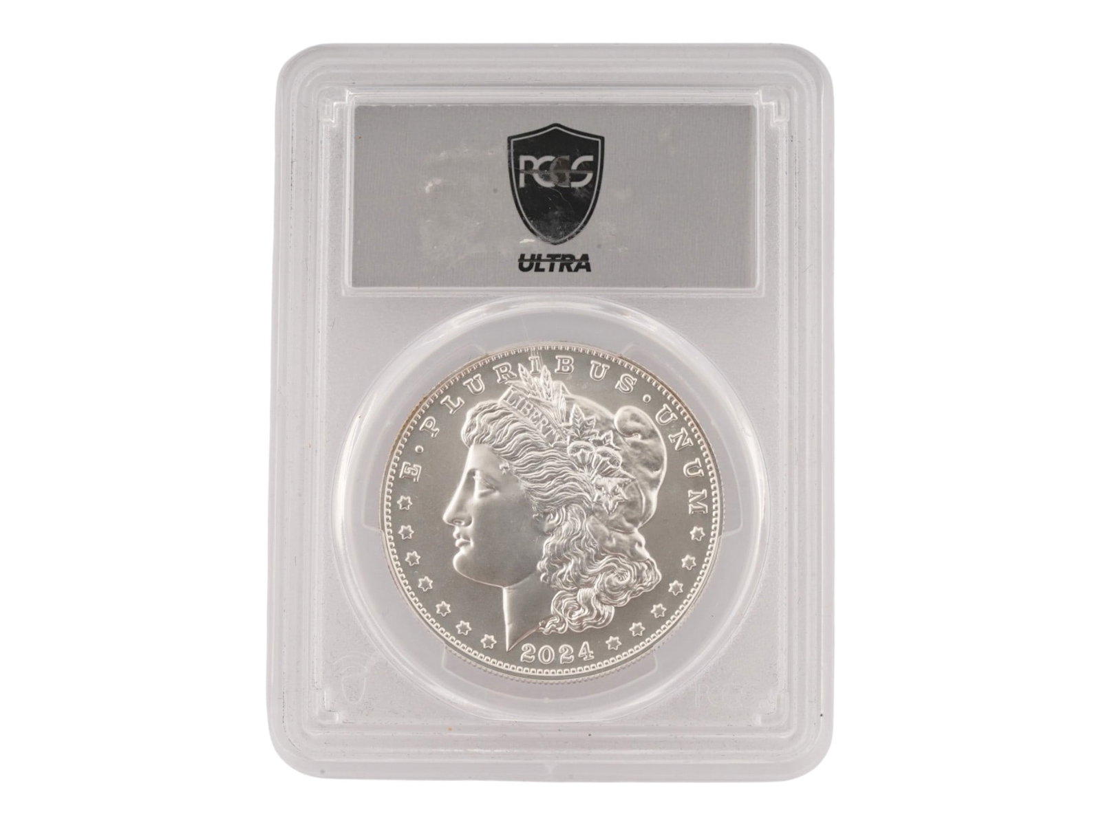2024 AMERICAN COMMEMORATIVE MORGAN SILVER DOLLAR GRADED: An American Morgan Silver Dollar, a commemorative release from the United States Mint, 2024. A modern strike of the iconic Morgan Dollar originally designed by George T. Morgan. It is sealed in a PCGS