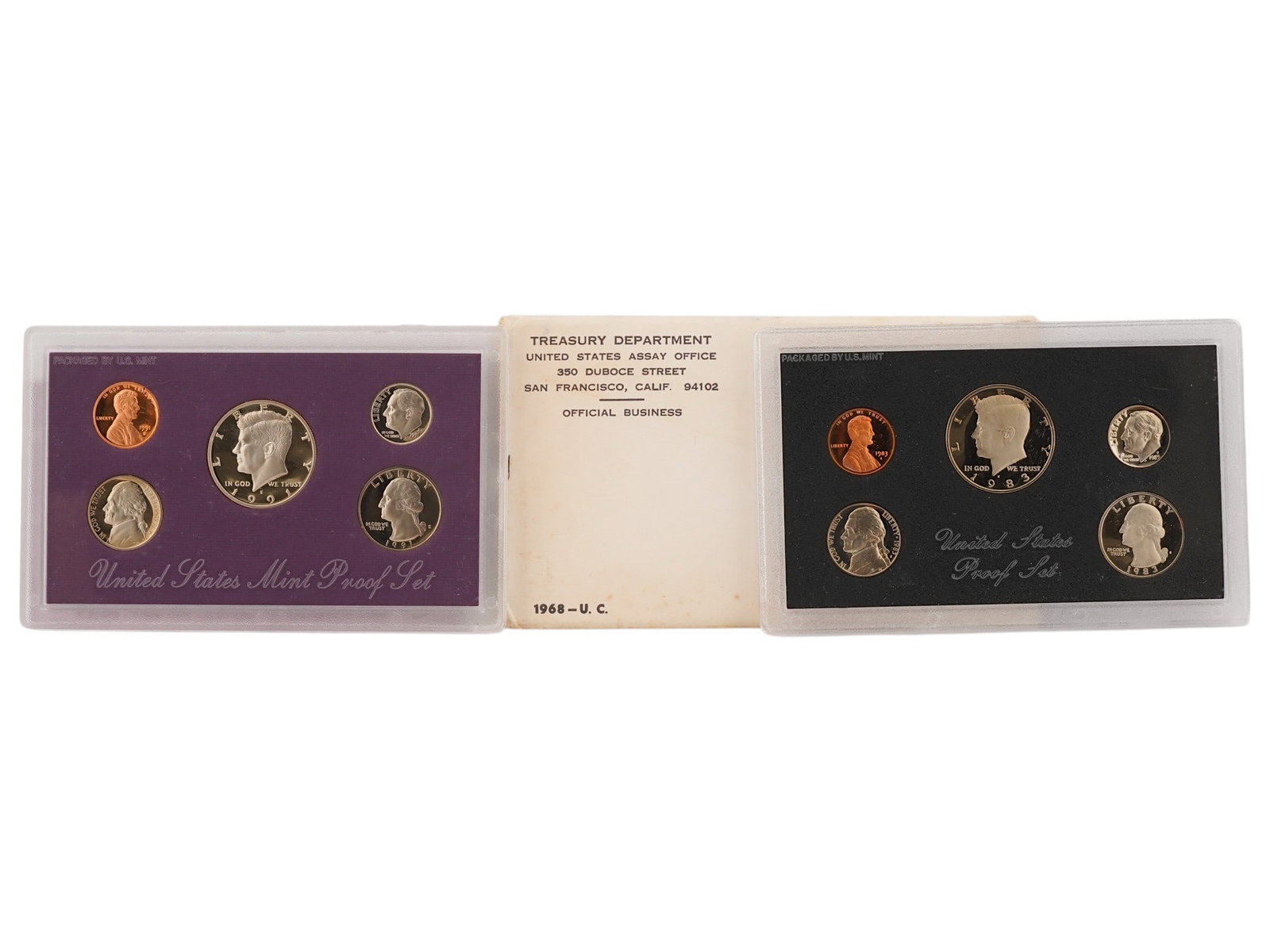1983 AND 1991 UNITED STATES MINT PROOF SET W COA: A 1983 and 1991 United States Mint Proof Set features five iconic American coins. The set includes the Lincoln cent, Jefferson nickel, Roosevelt dime, Washington quarter, and Kennedy half dollar, each