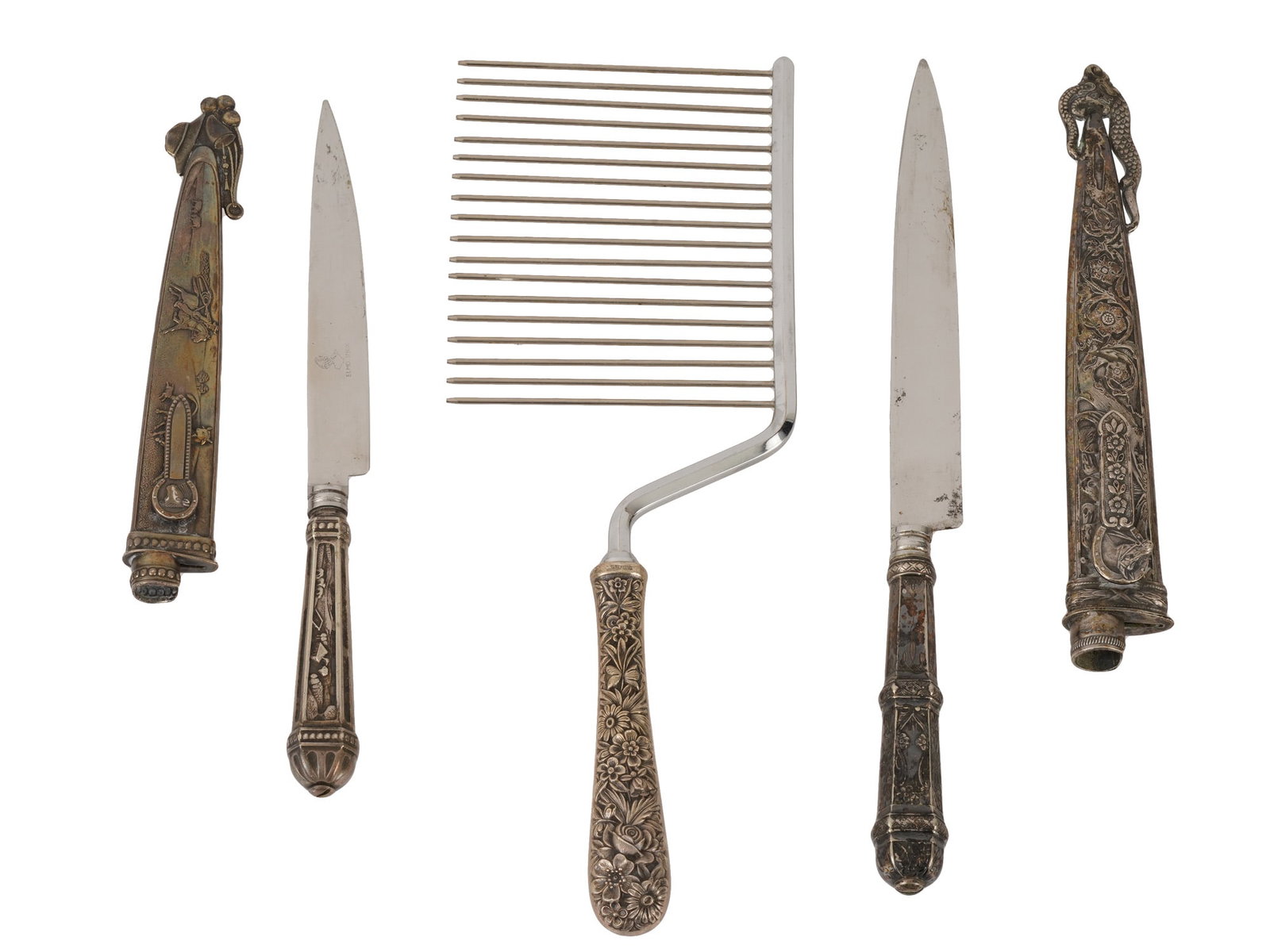 VINTAGE SILVER CUTLERY SET OF CAKE KNIVES AND COMB: An antique cutlery Silver set that includes a cake knife and a special tool called a cake breaker, also known as a cake comb. The handles of the ware are adorned with embossed and engraved design repr