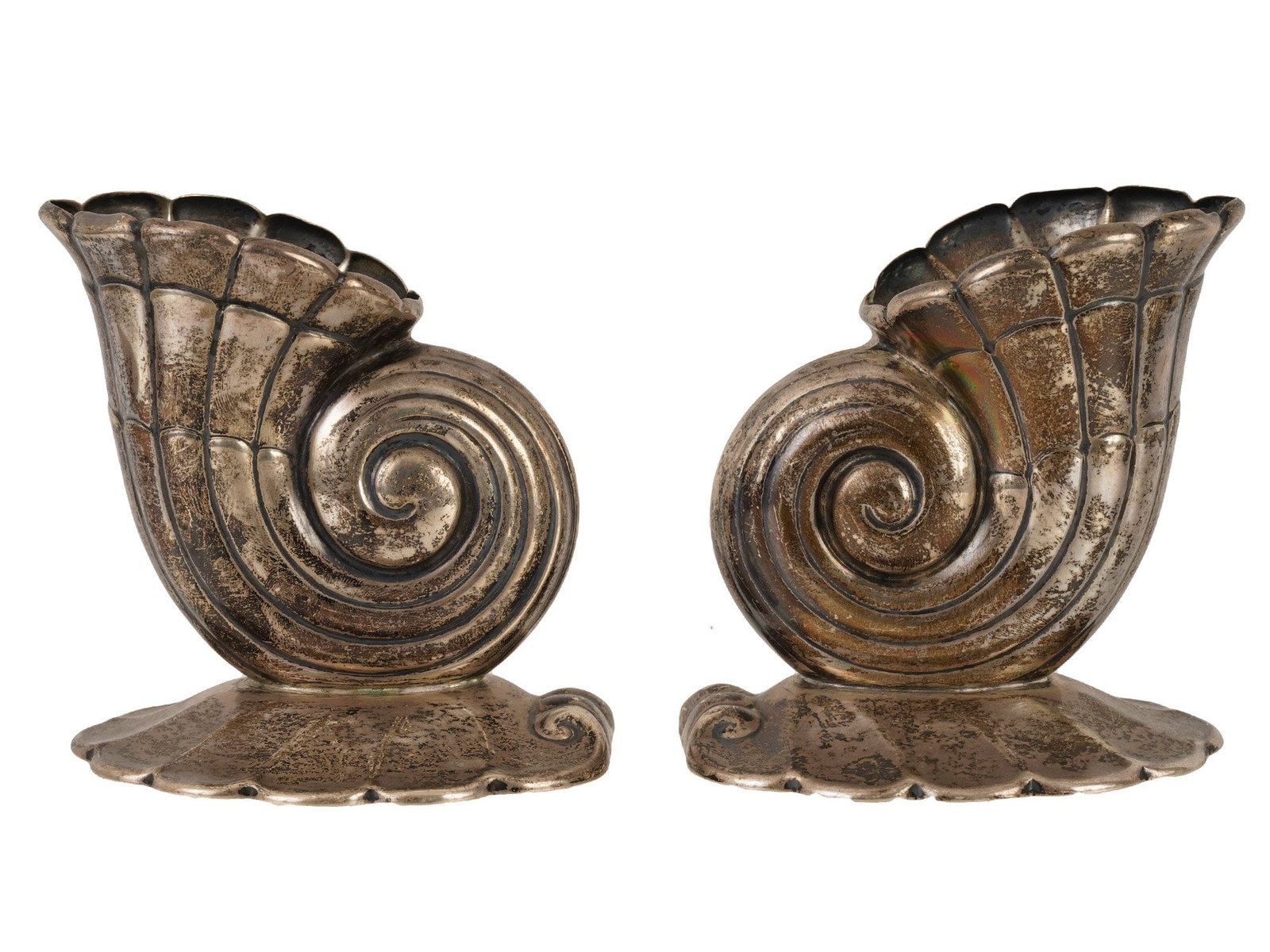 PAIR OF SHELL SILVER CANDLE HOLDERS BY FRANK W SMITH: A pair of Sterling Silver figural candle holders by Frank W. Smith. The wares are made in a sculptural design representing a sea shell, engraved with detailed patterns. Each is mounted on a base featu
