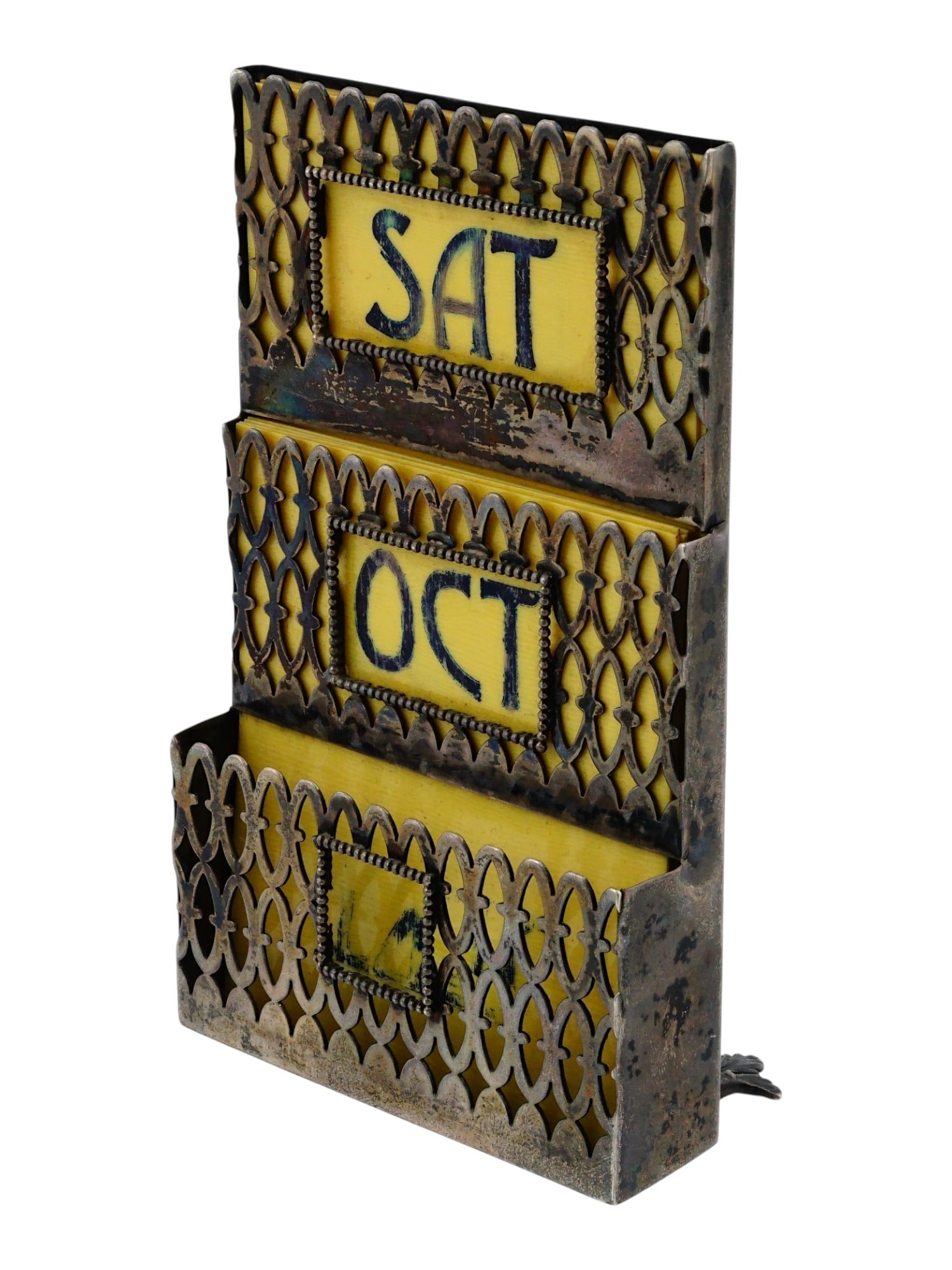 VINTAGE STERLING SILVER PERPETUAL DESK CALENDAR: A vintage sterling silver perpetual desk calendar, featuring an ornate pierced lattice design. The structure is organized into three tiered horizontal apertures, housing the original printed card inse