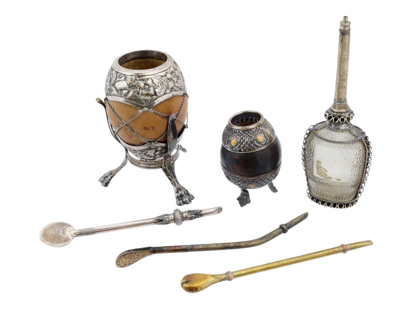 VINTAGE SOUTH AMERICAN YERBA MATE DRINKING SETS: Vintage traditional South American yerba mate drinking sets comprising silver and silver-plated components, including ornate mounted gourds, bombillas, and three spoons. The collection features mate