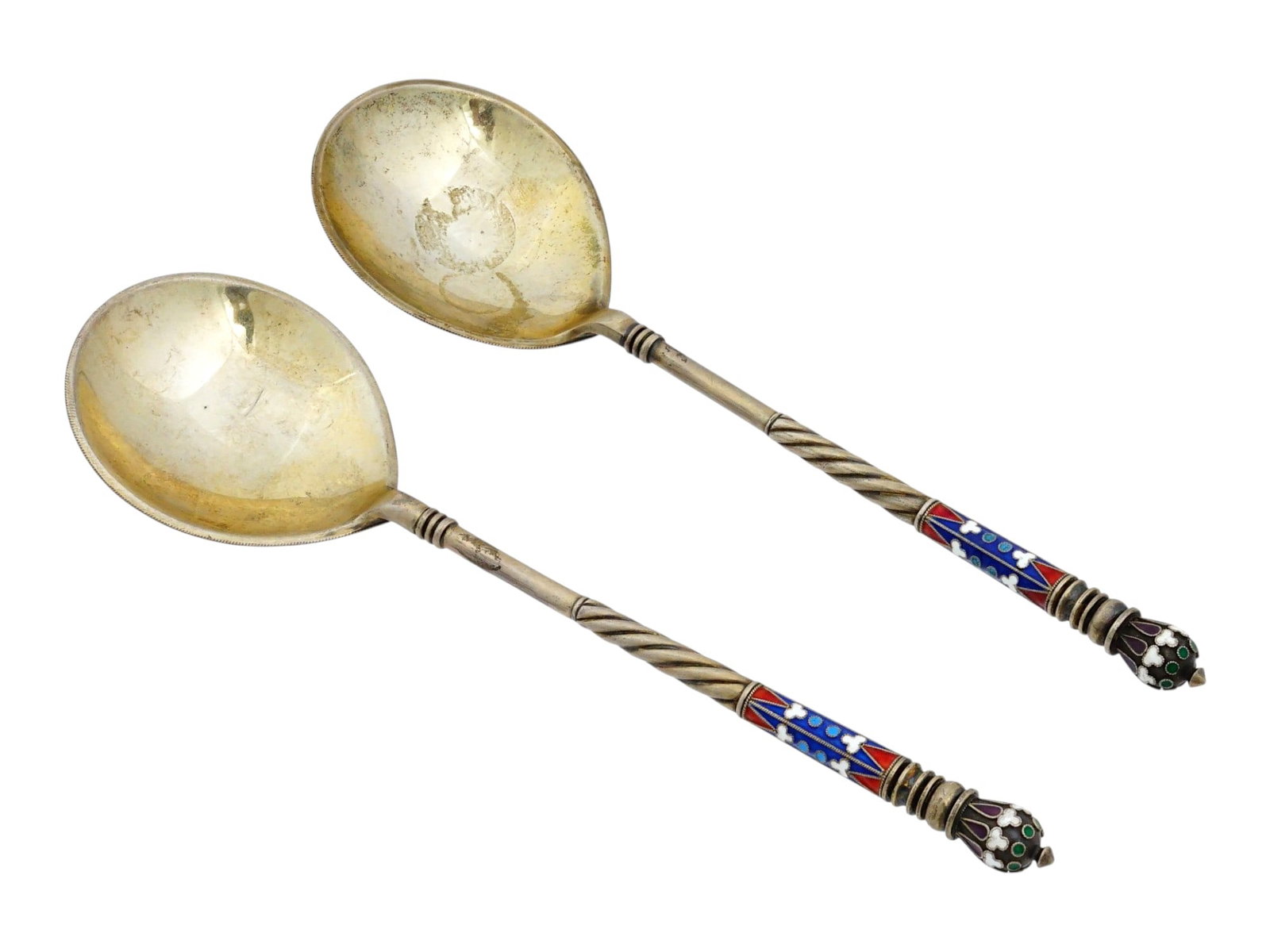 RUSSIAN IMPERIAL GILT SILVER CLOISONNE ENAMEL SPOONS: Two Russian Imperial gilt silver and cloisonne enamel spoons. Adorned with floral and geometric enamel decoration, one spoon features the Imperial Russian double-headed eagle, while the other bears th