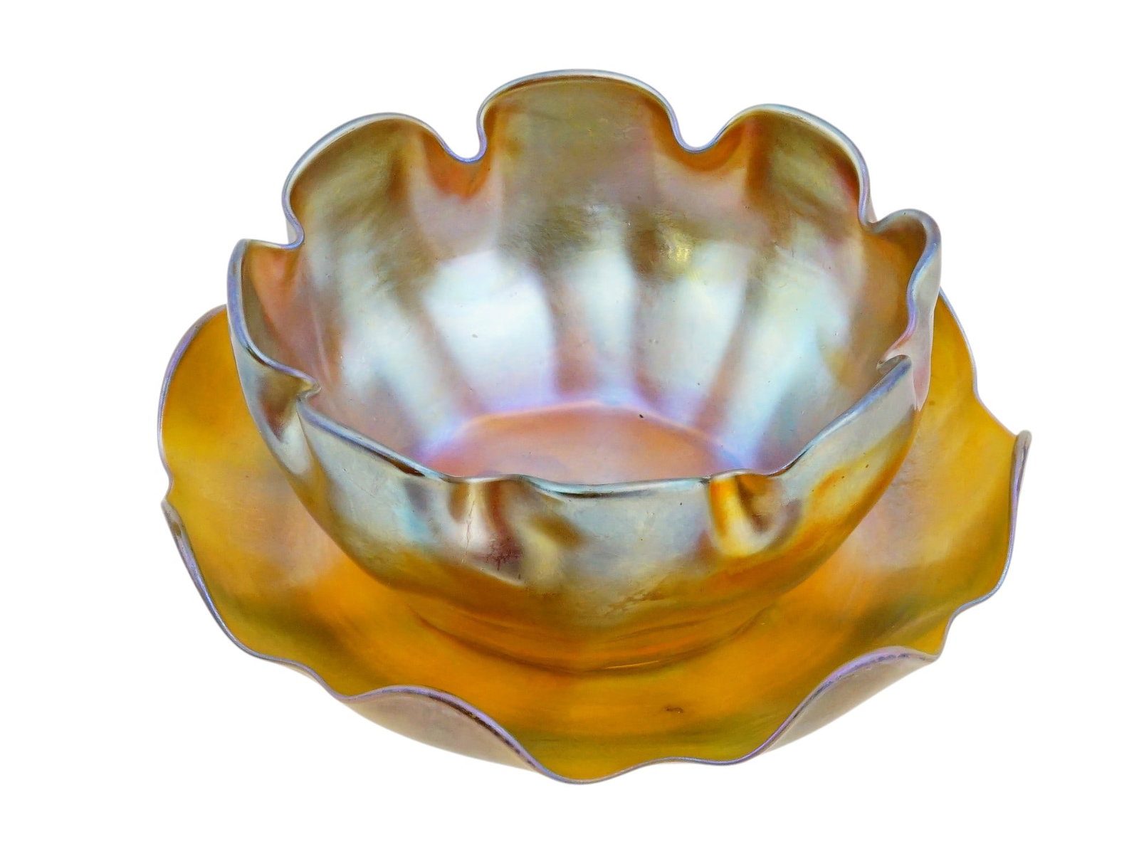 VINTAGE TIFFANY FAVRILE GLASS FINGER BOWL AND SAUCER: A vintage Favrile glass finger bowl and saucer set by Tiffany Studios, created in the celebrated iridescent glass technique developed by Louis Comfort Tiffany. Executed in shimmering gold iridescent g