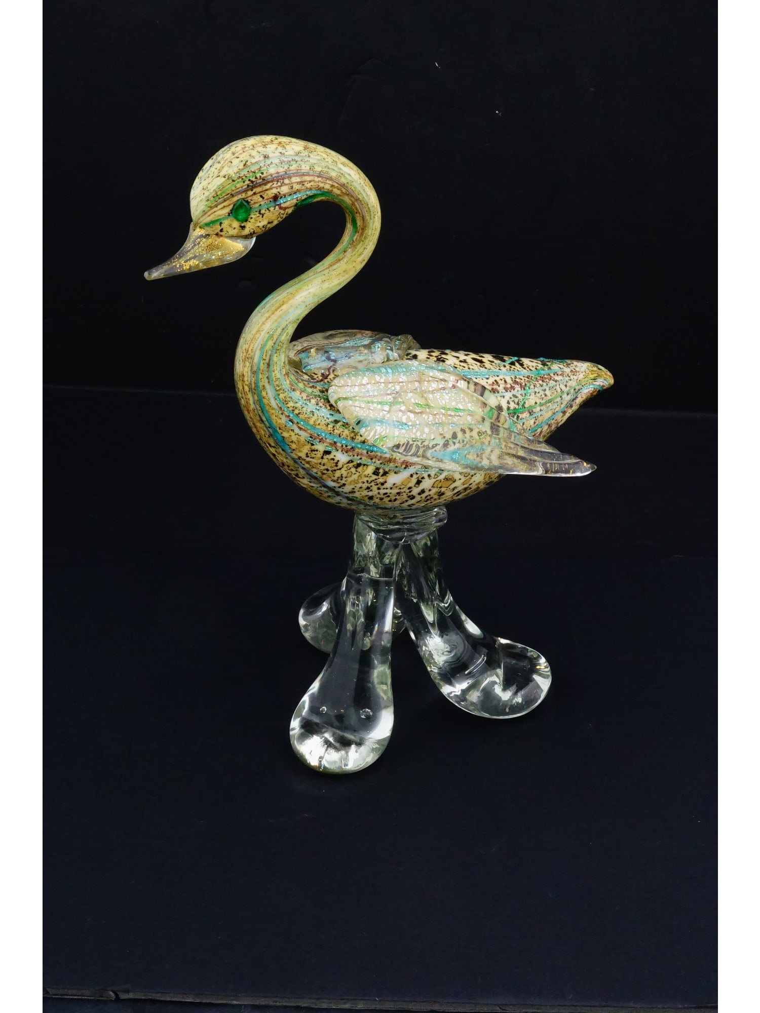 ITALIAN MANNER HAND BLOWN ART GLASS FIGURINE OF BIRD: An Italian manner hand blown art glass figurine. The figurine depicts a bird characterized by a gracefully arched neck and a multi colored interior. The body features intricate internal patterning wit