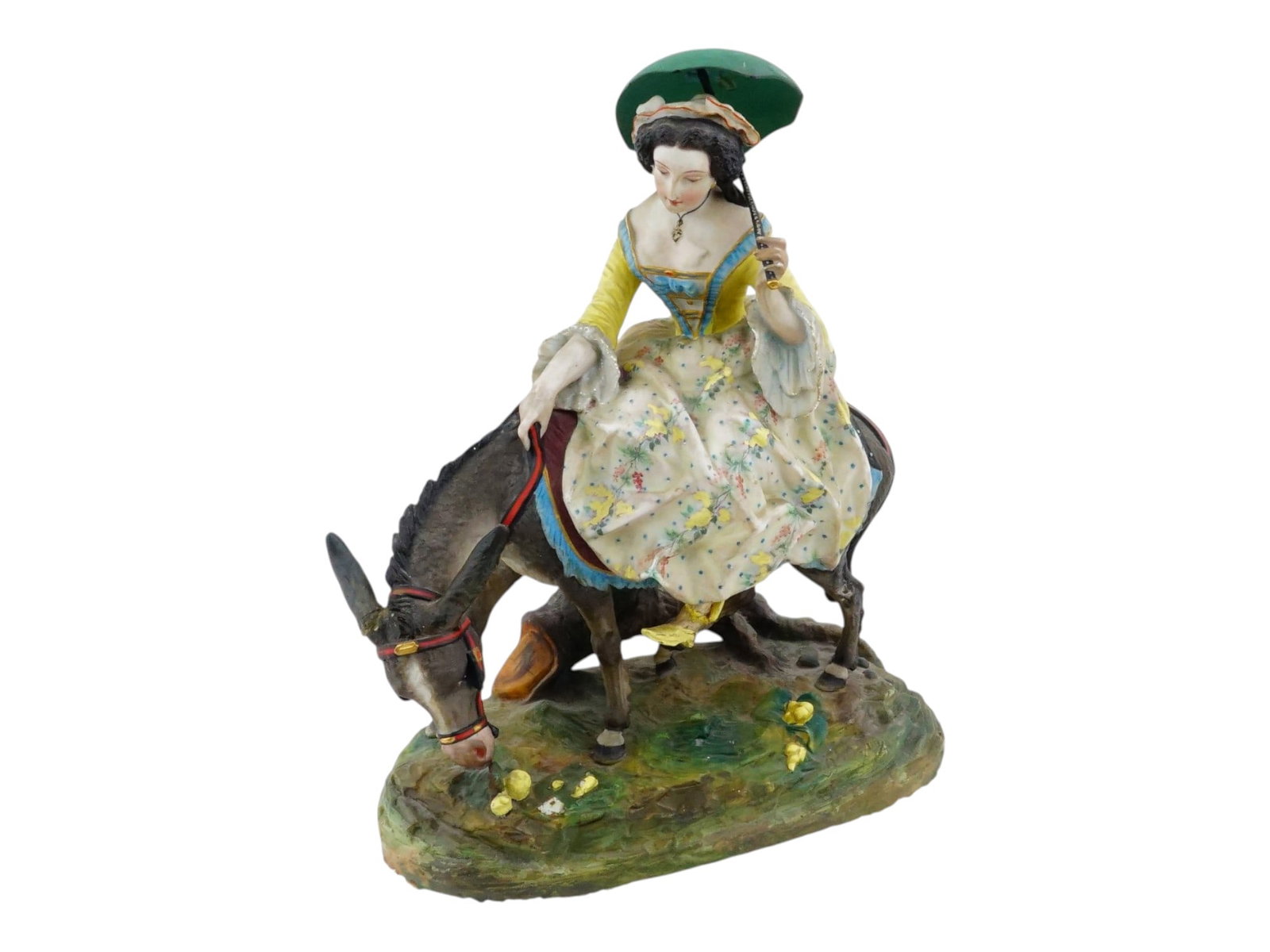 ANTIQUE EUROPEAN PORCELAIN FIGURE WOMAN ATOP A DONKEY: An antique European porcelain figural group depicting an elegantly dressed woman in 18th-century attire seated atop a donkey. Executed in the Rococo Revival taste popular during the late 19th and earl