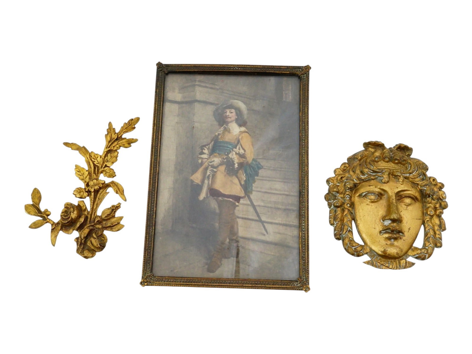 ANTIQUE EUROPEAN ORNAMENTS AND FRAMED REPRODUCTION: A group of antique European ornaments featuring a bronze-framed reproduction of A Cavalier, Time of Louis XIII by Jean-Louis-Ernest Meissonier, alongside two ornate gilt metal appliques, including a R
