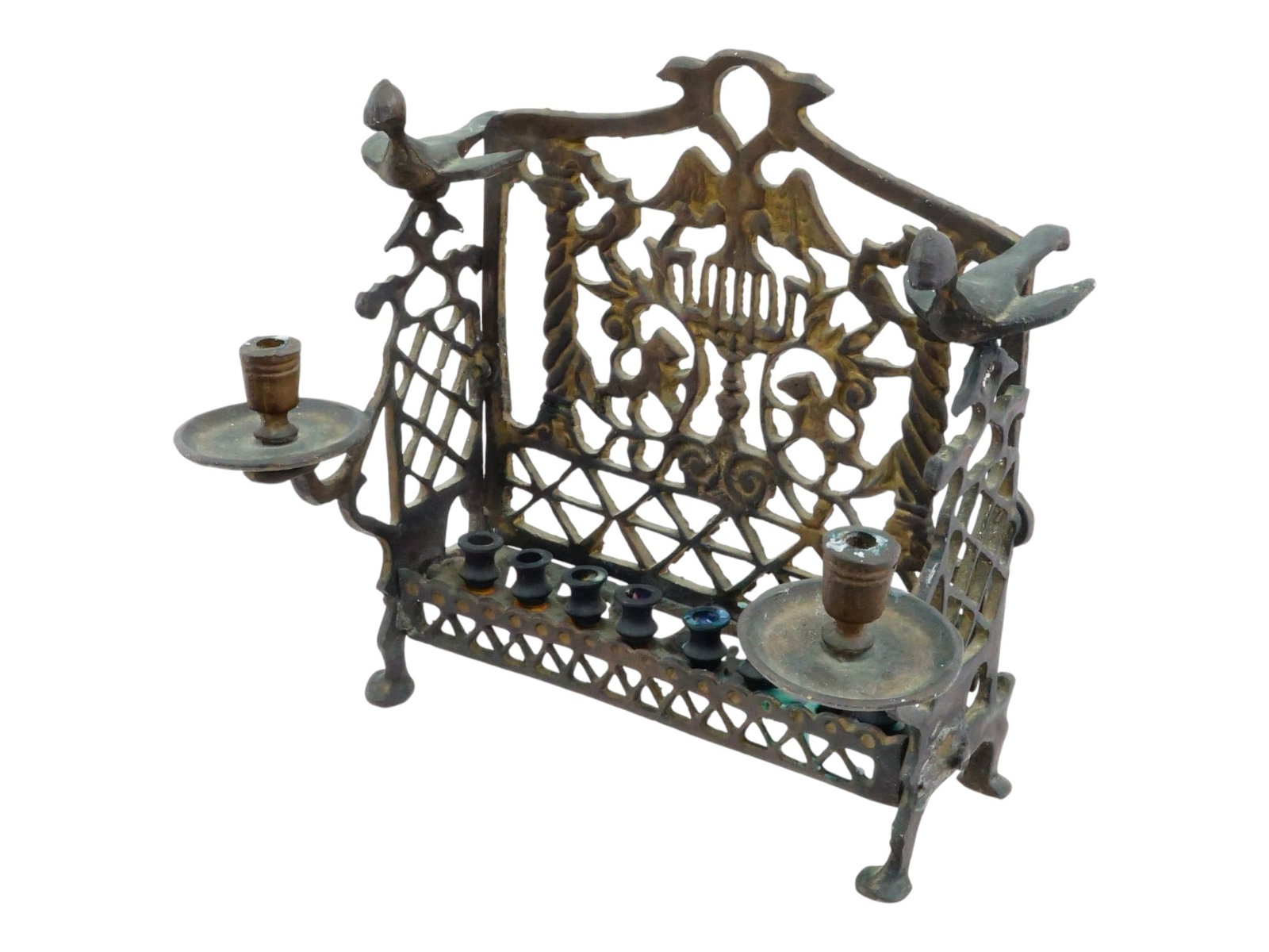 ANTIQUE POLISH JUDAICA BRASS HANUKKAH MENORAH: An antique 19th-century Polish Hanukkah menorah made of cast brass. Designed as an ornate bench with bird and lion motifs, as well as the Imperial Russian double-headed eagle. Fronted with a row of ei