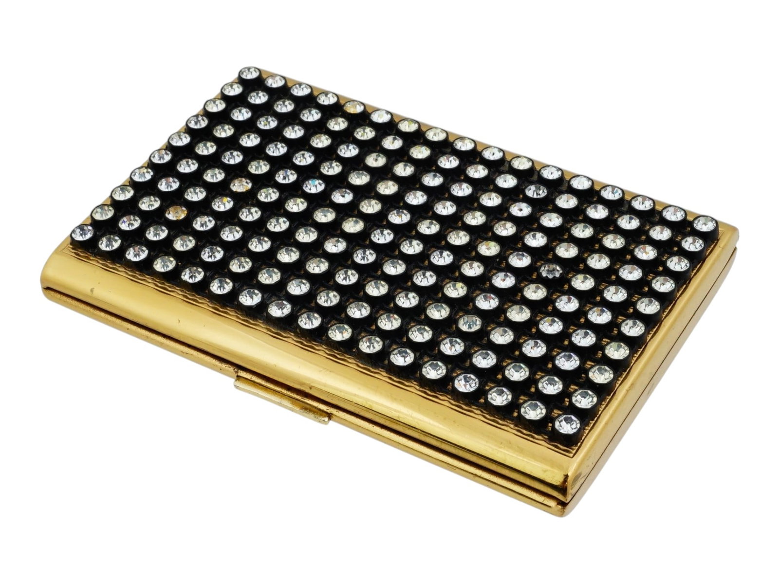 VINTAGE BRONZE VANITY COMPACT W CUBIC ZIRCONIA STONES: A vintage decorative vanity compact crafted in bronze and accented with cubic zirconia stones. The piece combines the elegance of vintage compact design with jewel-like detailing. Dating to the late 2
