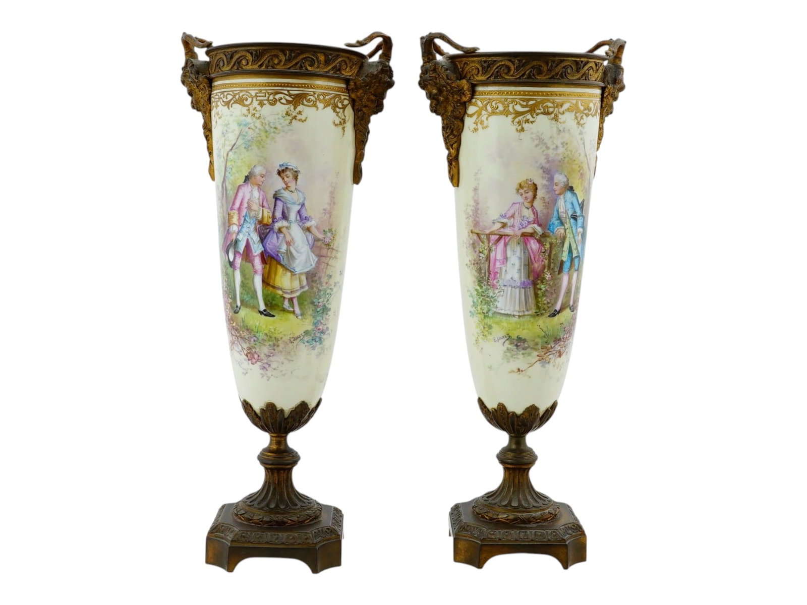 ANTIQUE FRENCH SEVRES GILT BRONZE PORCELAIN URNS: A pair of antique French Sevres porcelain urns, richly decorated with gilt bronze ormolu mounts. Executed in the amphora form, each vase features a finely painted central medallion depicting courting 