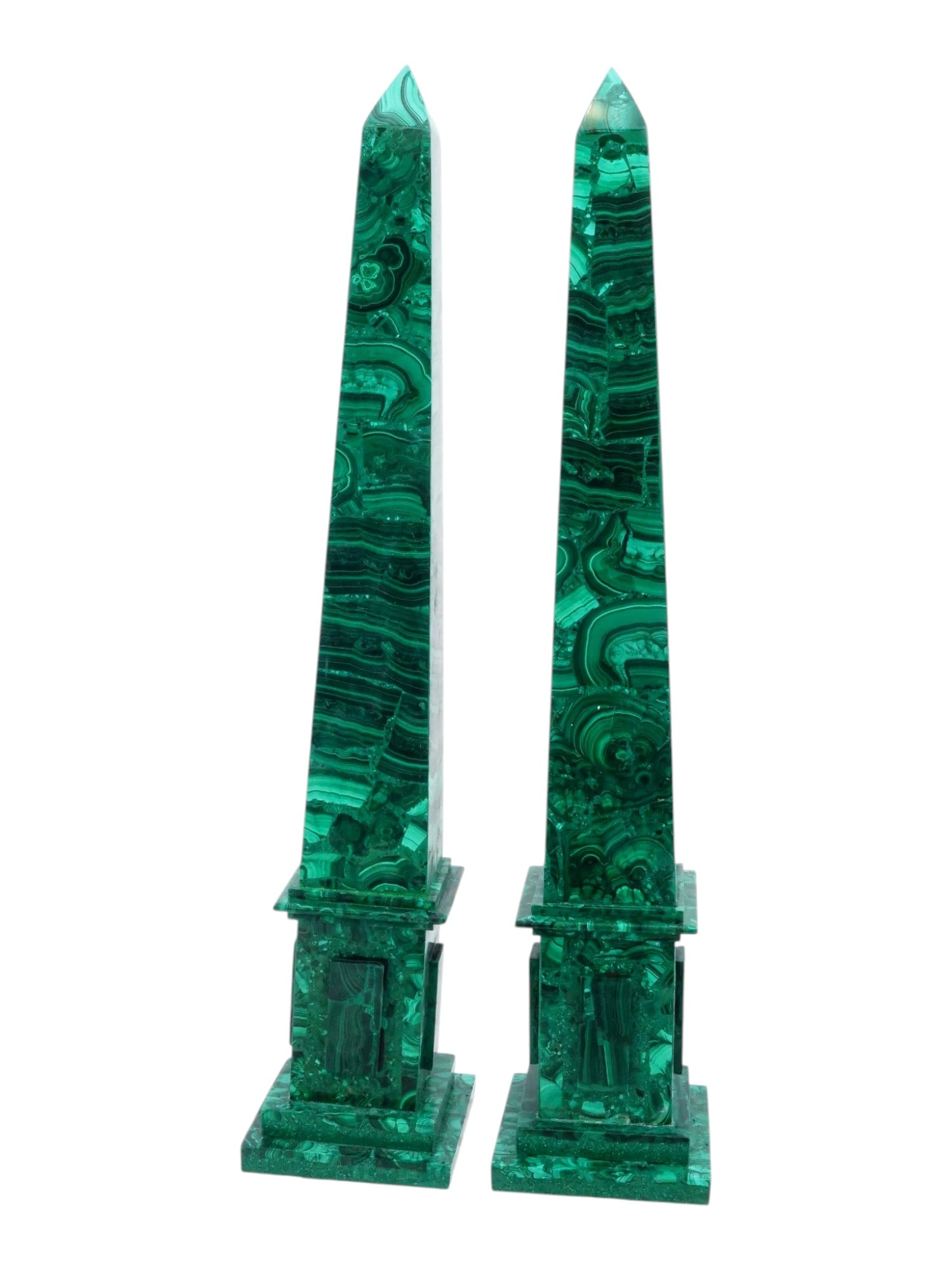 PAIR OF NEOCLASSICAL CARVED MALACHITE OBELISKS: A pair of carved malachite veneered obelisks executed in the Neoclassical style, each featuring a tapering four-sided shaft terminating in a pyramidal apex. The shafts are supported by square-sectione