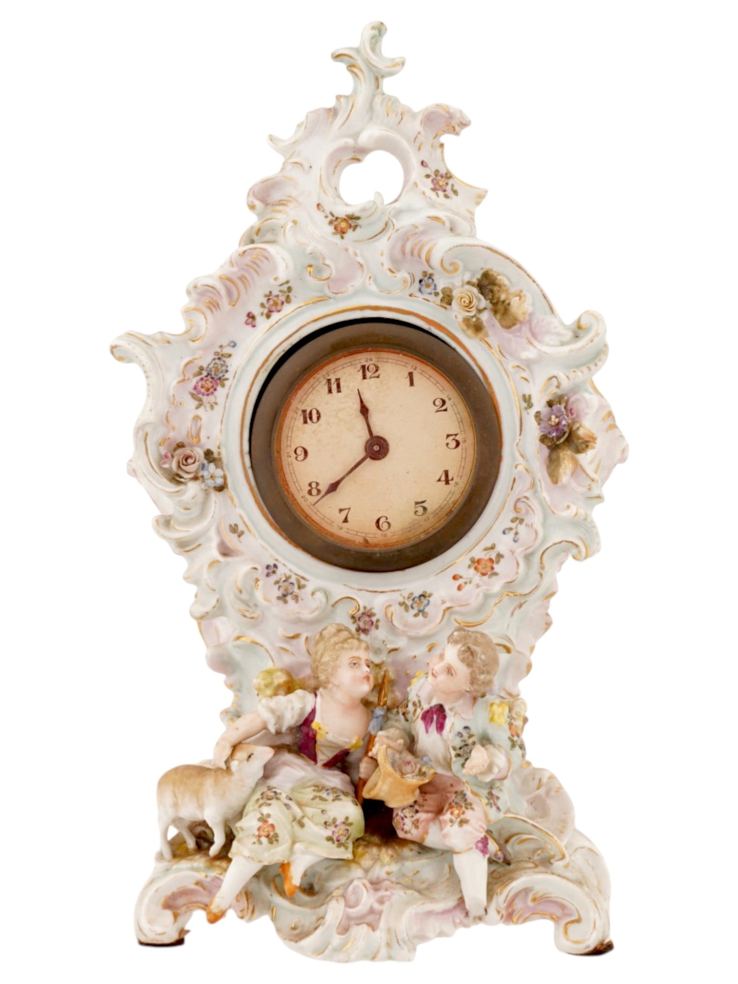 ANTIQUE GERMAN PORCELAIN ROCOCO MANTLE CLOCK: An antique German porcelain figural mantle clock in the Rococo style, which is characterized by graceful forms, an abundance of stucco flowers and rocaille curls. A white enamel dial with Roman numera
