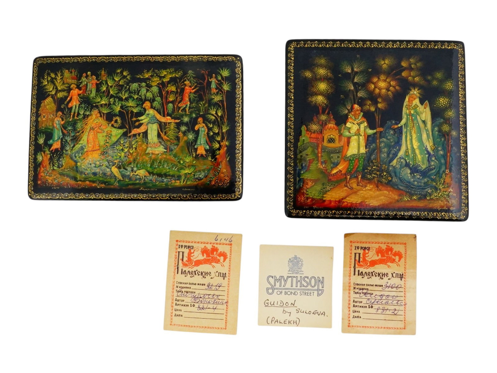 VINTAGE RUSSIAN HAND PAINTED LACQUER BOXES FROM PALEKH: Two vintage Russian hand-painted lacquer boxes from the celebrated village of Palekh, accompanied by their original certificates of authenticity. One depicts scenes from the Russian folk tale The Snow