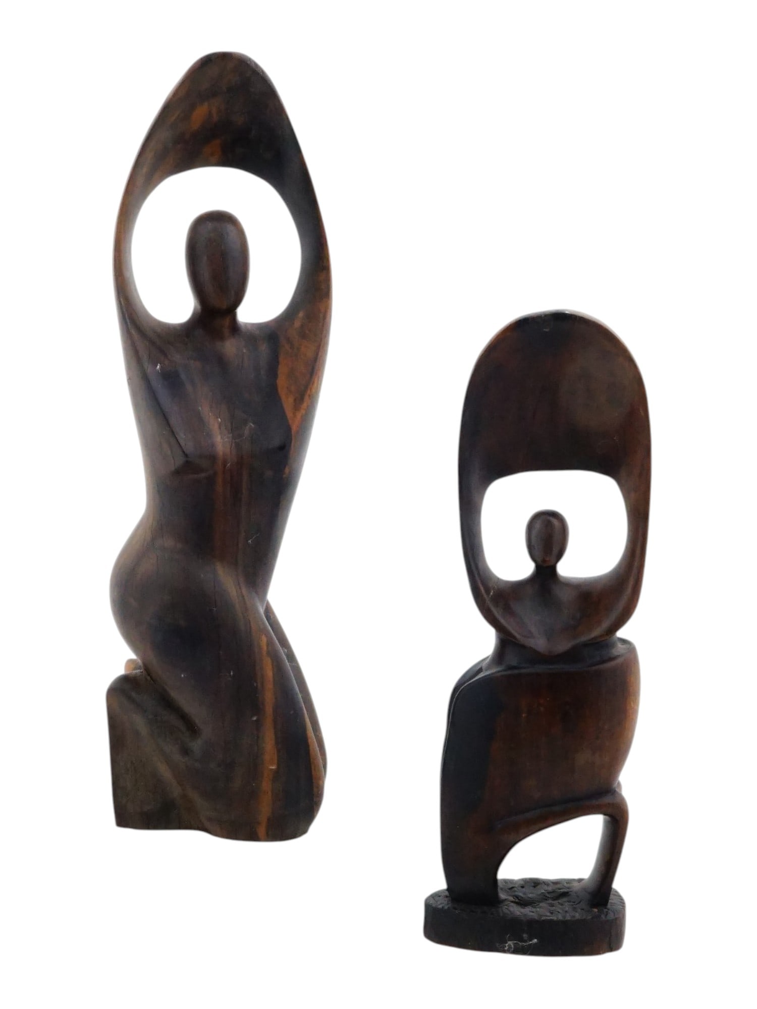 TWO VINTAGE AFRICAN HAND CARVED WOOD FIGURINES: A lot of two vintage African hand carved wood figurines. Circa mid-20th century. Both figurines have a smooth, flowing surface and resemble dancing female figures. Vintage African Wooden Home Decor Co