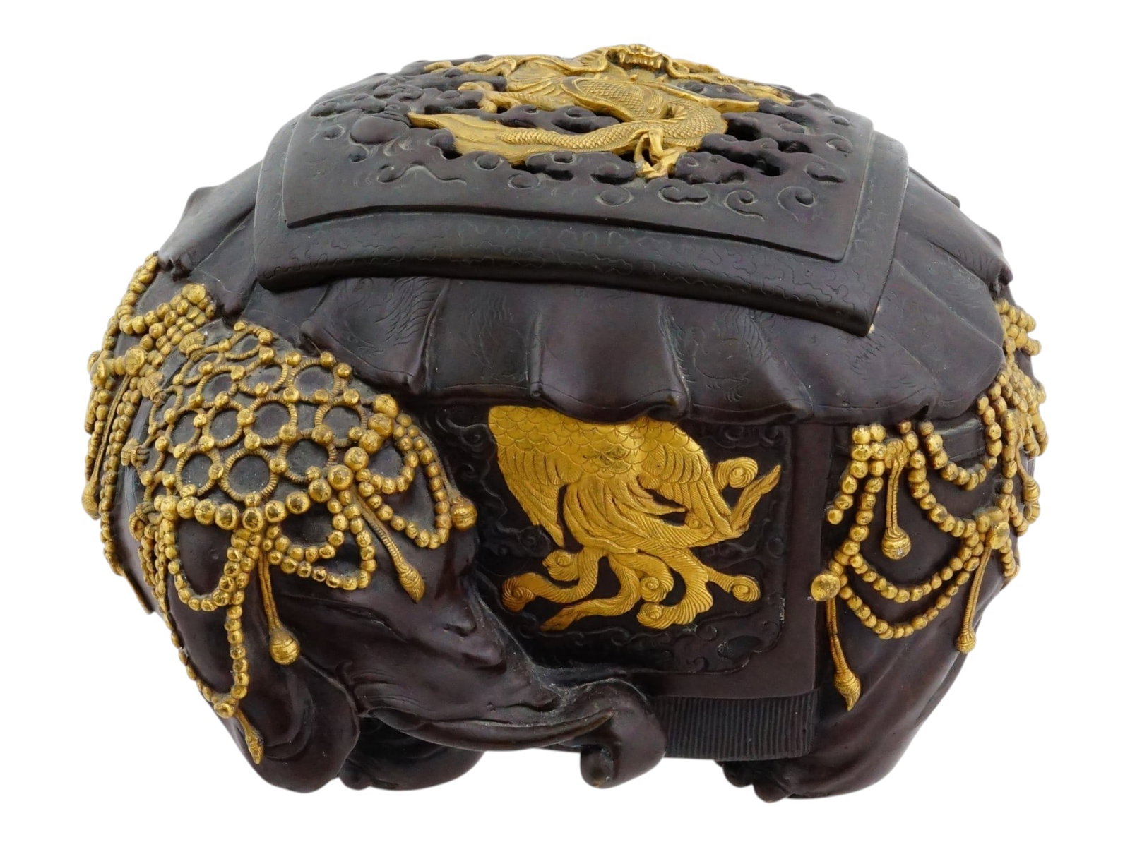 JAPANESE BRONZE KORO INCENSE BURNER W GOLD INLAY: A fine, well detailed Japanese bronze koro or incense burner in the shape of an elephant. The elephant features a globular body supported by four short feet and a matching pierced lid. The exterior is